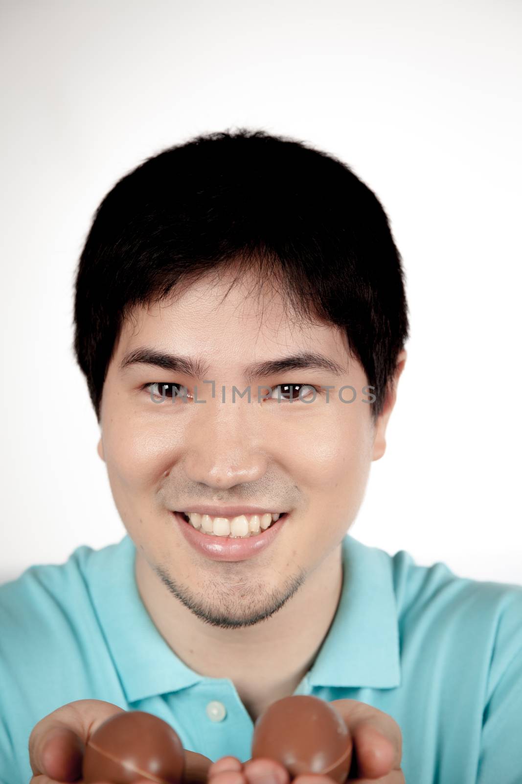 20-25, asian, background, caucasian, decoration, easter, egg, event, felicity, giving, hand, handmade, happy, holding, hope, human, life, male, man, model, old, one, palm, people, person, portrait, property, releases, seasonal, show, showing, smile, smiling, studio, symbol, traditional, white, years, young