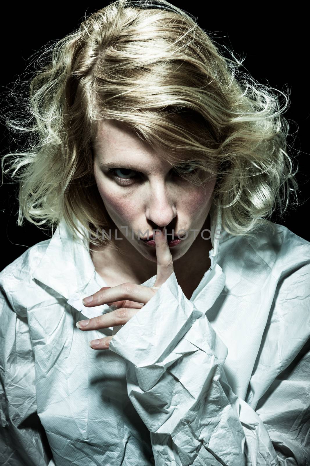 Psycho Woman asking for Silence with Finger on Lips