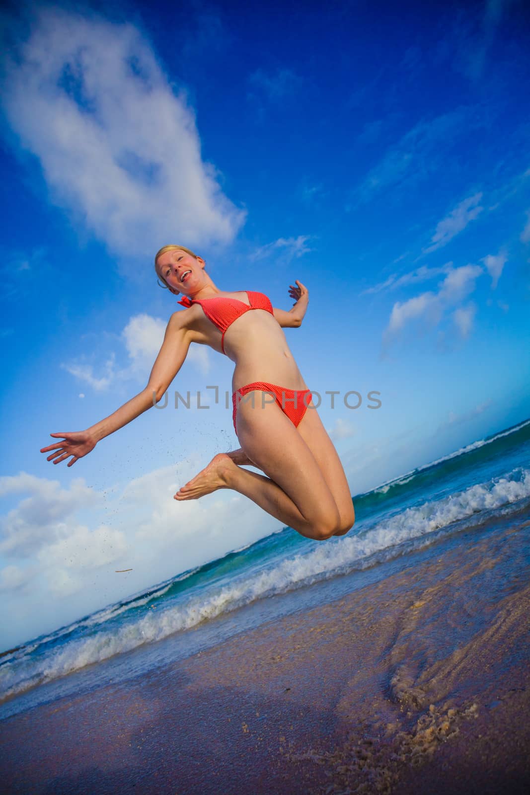 Happy Woman Jumping on the Beach by aetb
