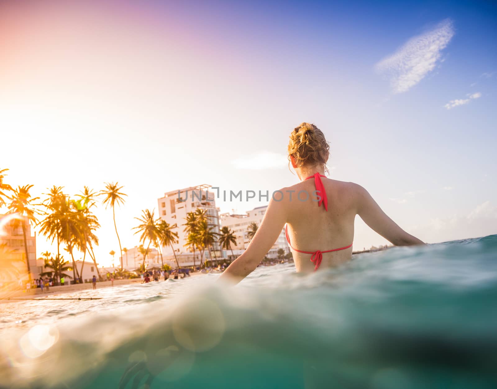 Woman at the Sea in a tropical Climate and enjoying the hot Water.