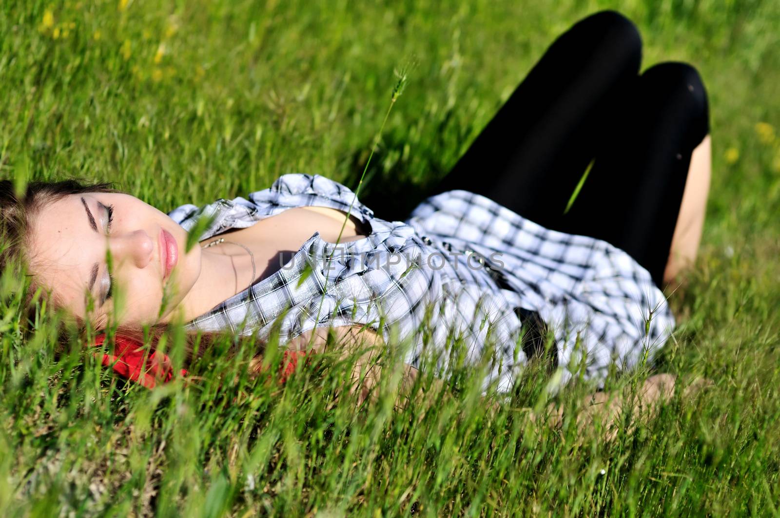 sweet tender teen girl dreaming in the high grass 