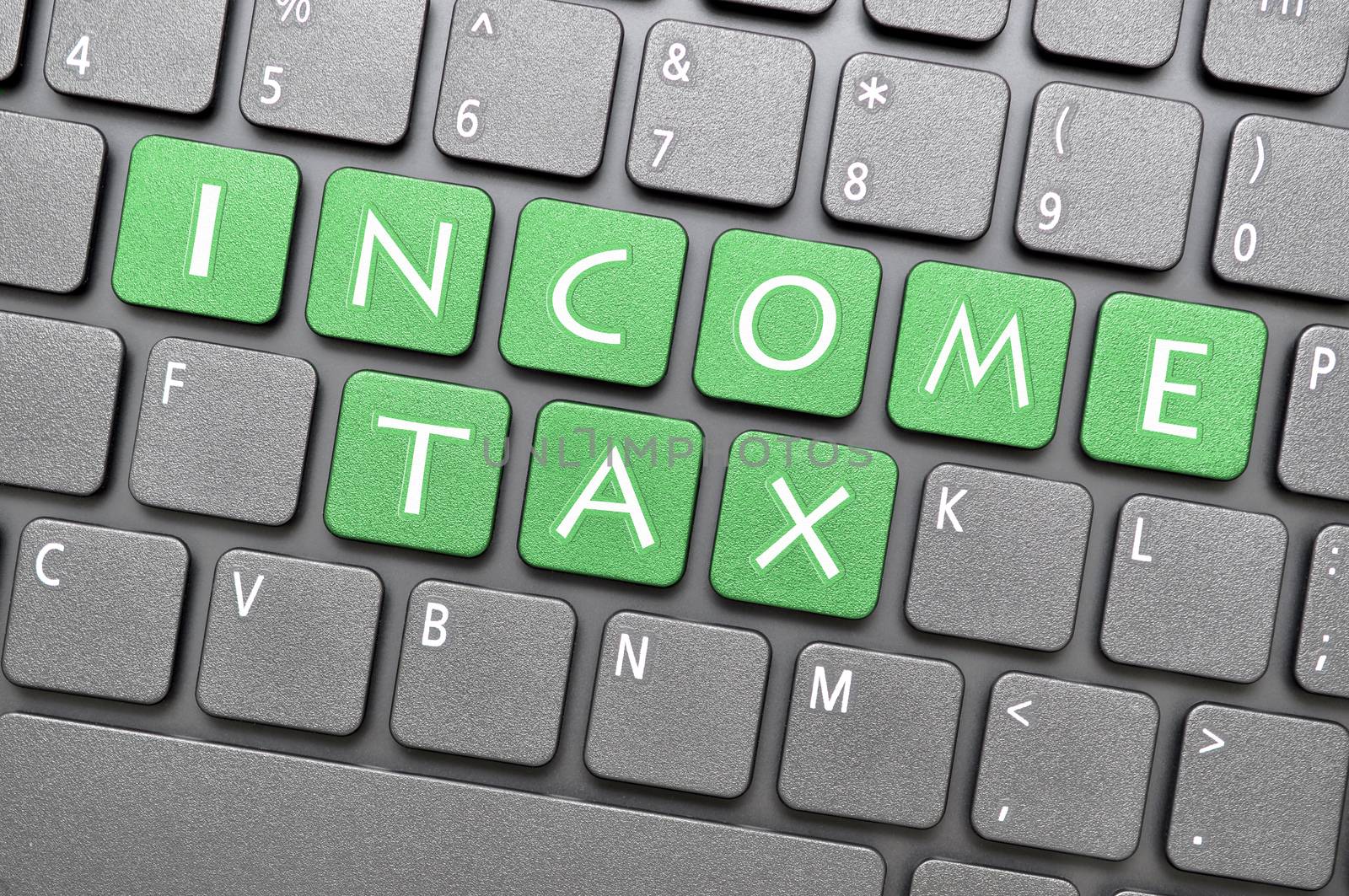 Green income tax key on keyboard