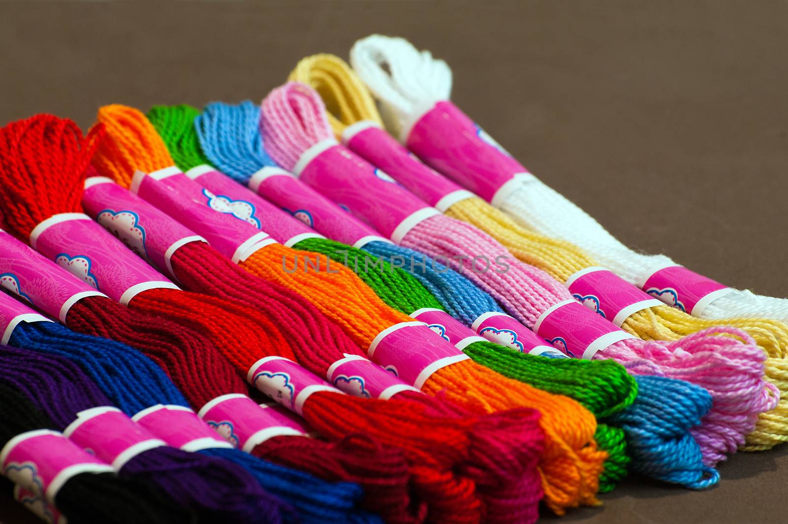 Multi-coloured embroidery floss in skein on plain background
