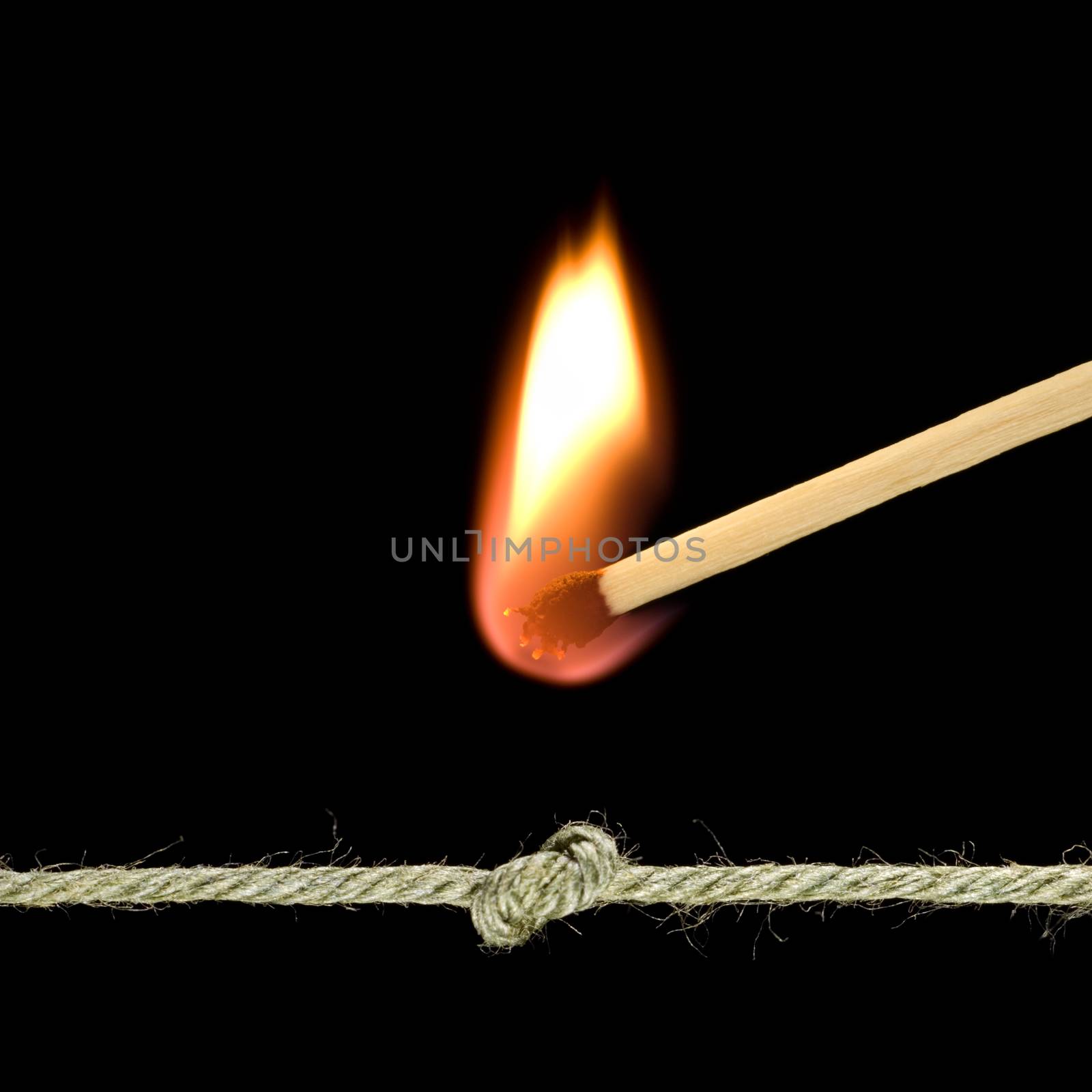 Unit on a cord and a burning match.
Black background.