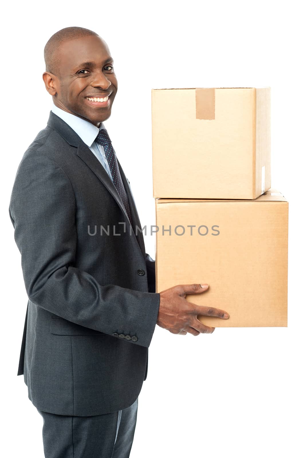 Smiling handsome male carrying cardboard box