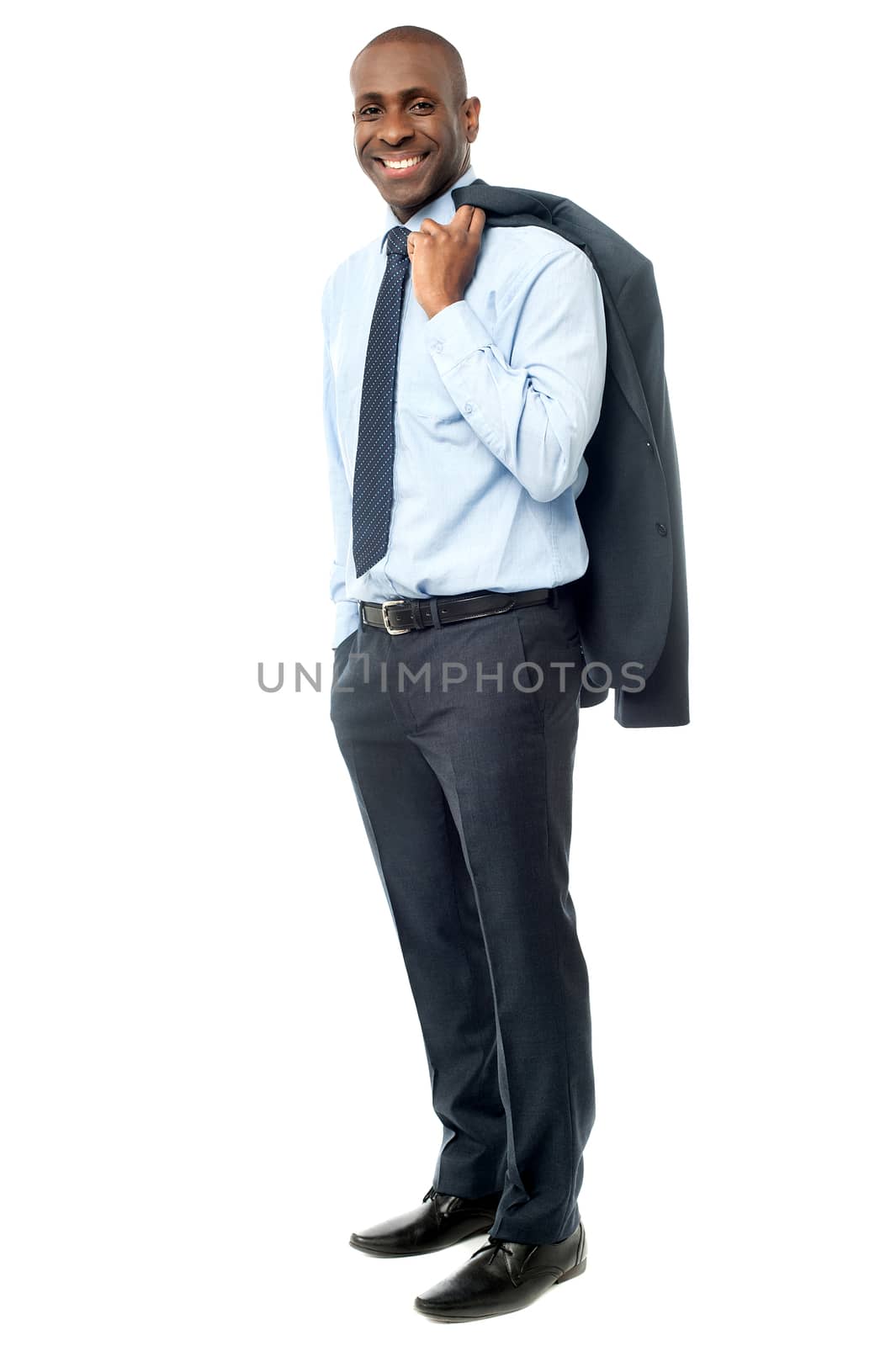 Businessman stands with his jacket over his shoulder