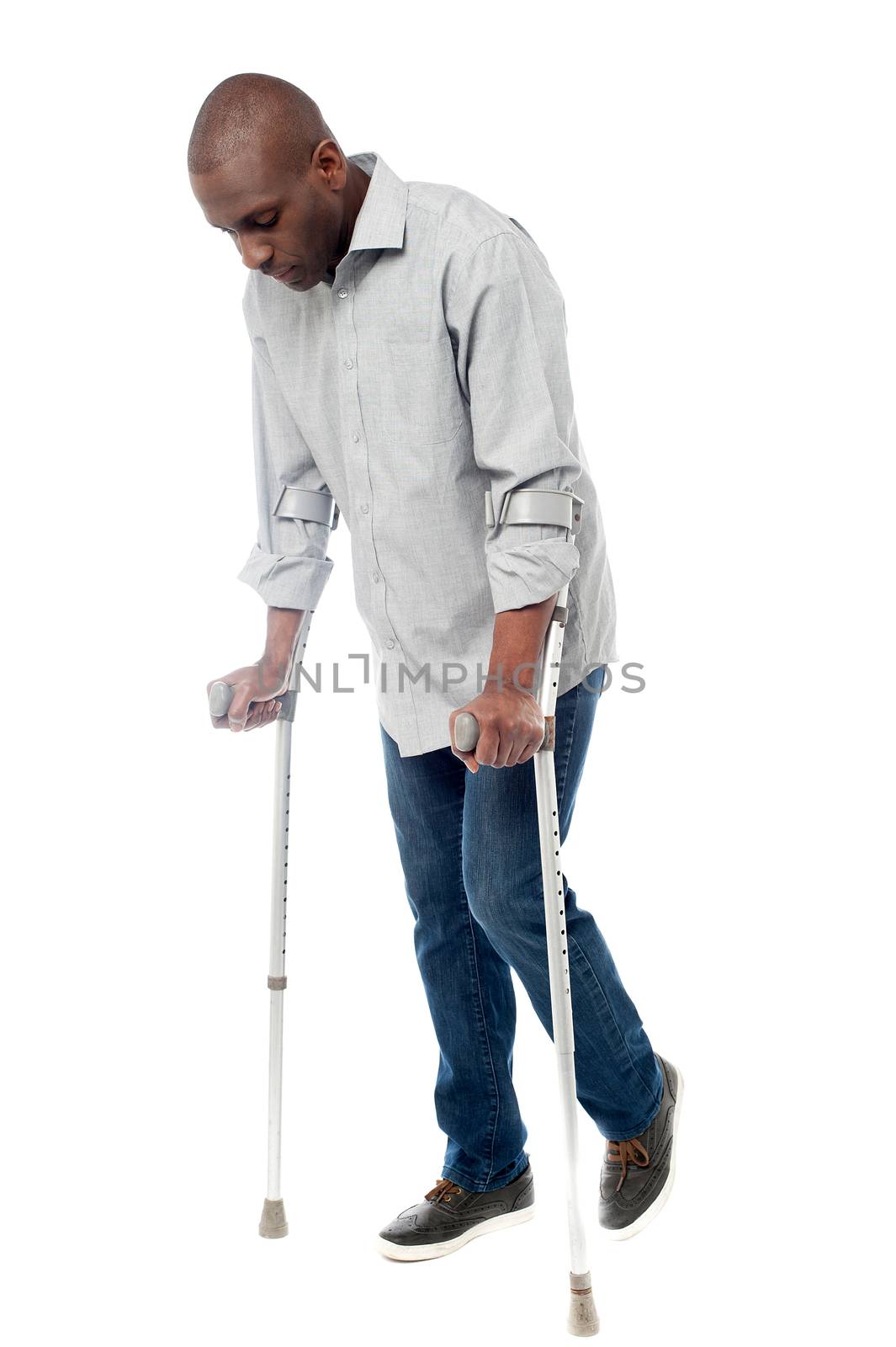 Man walking with crutches isolated on a white