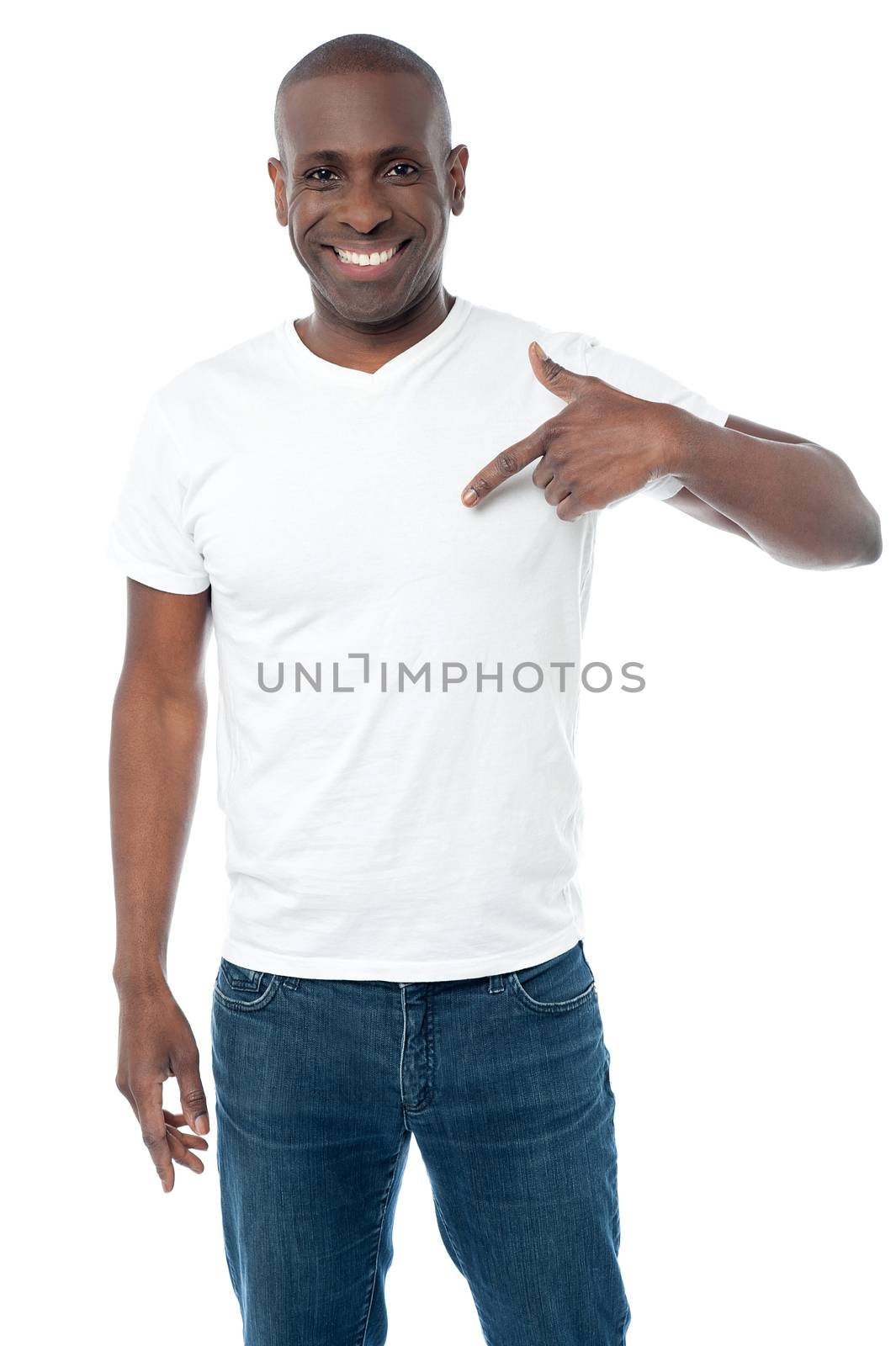 Middle aged man pointing his fingers on a blank t-shirt