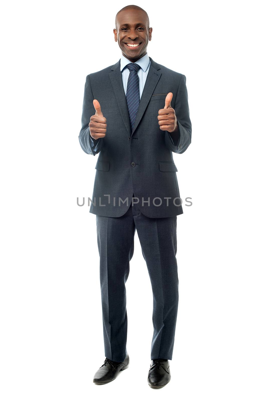 Smiling young man with showing thumbs up