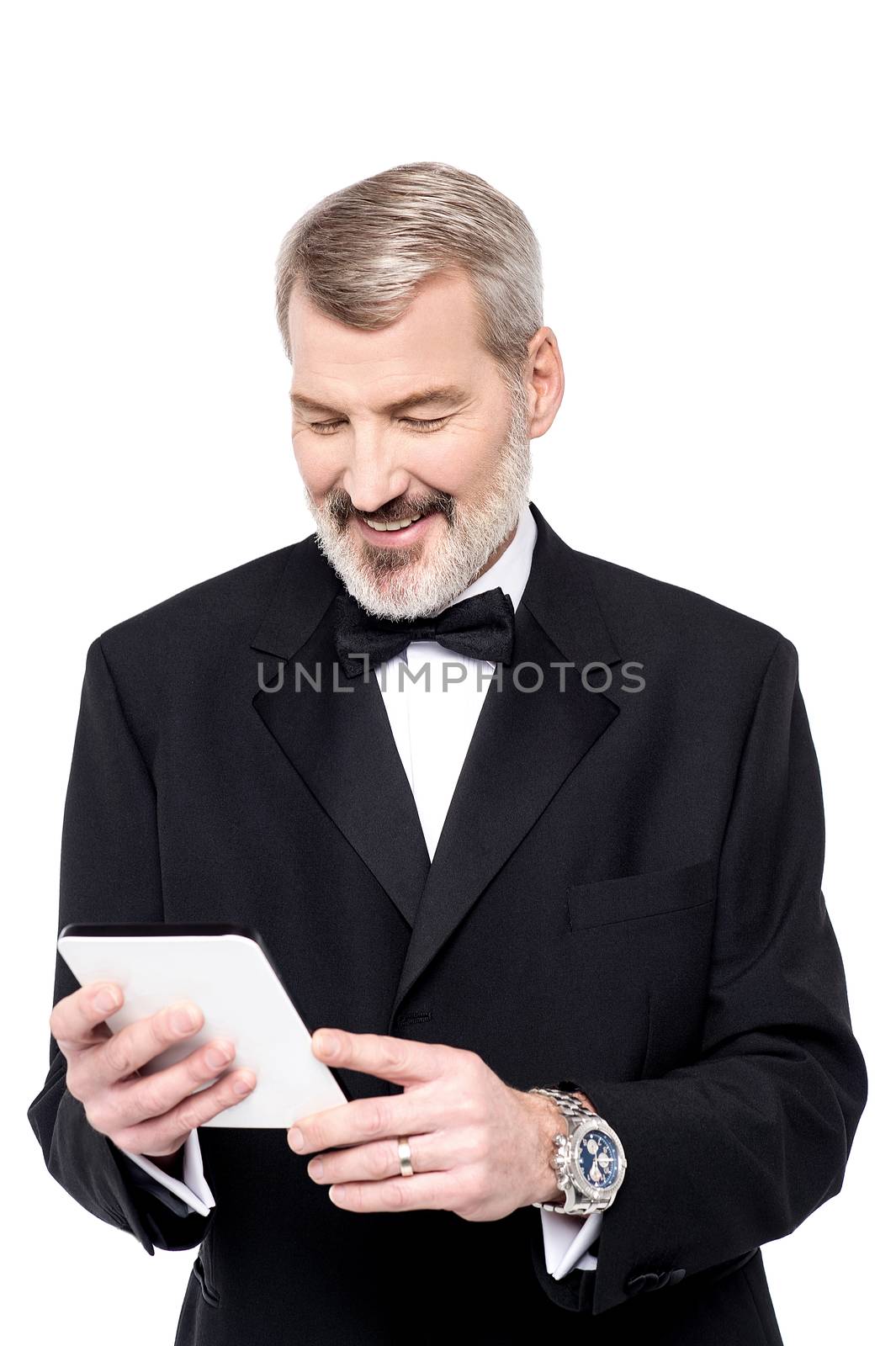 Cheerful businessman reading news on his tablet pc