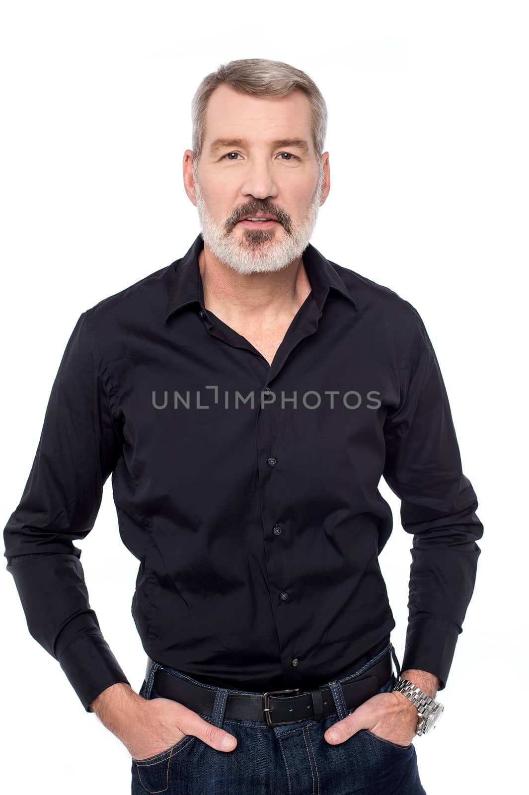 Elderly man posing with hands in his pockets