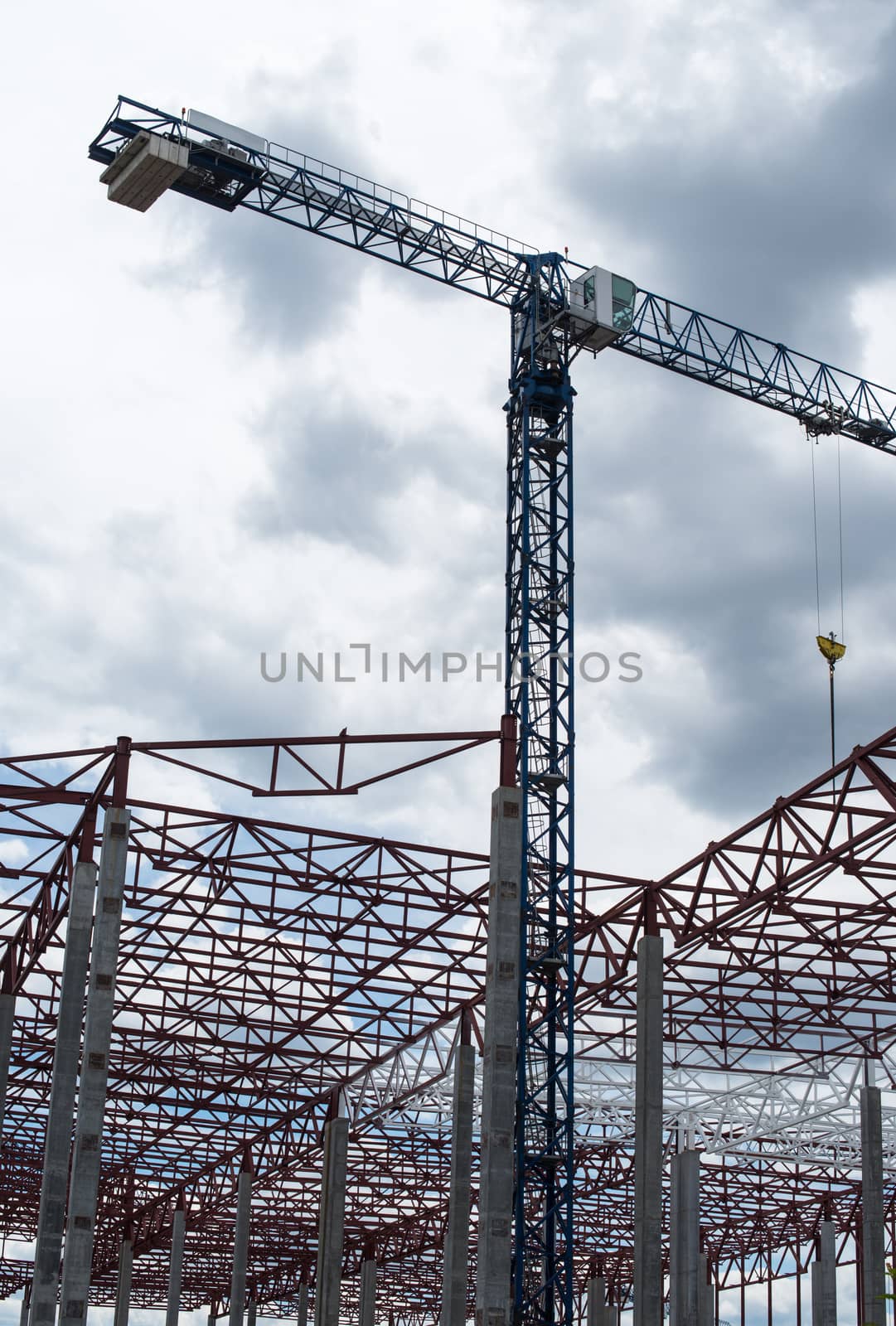 Construction site. Framework of the new building and tower crane above it.