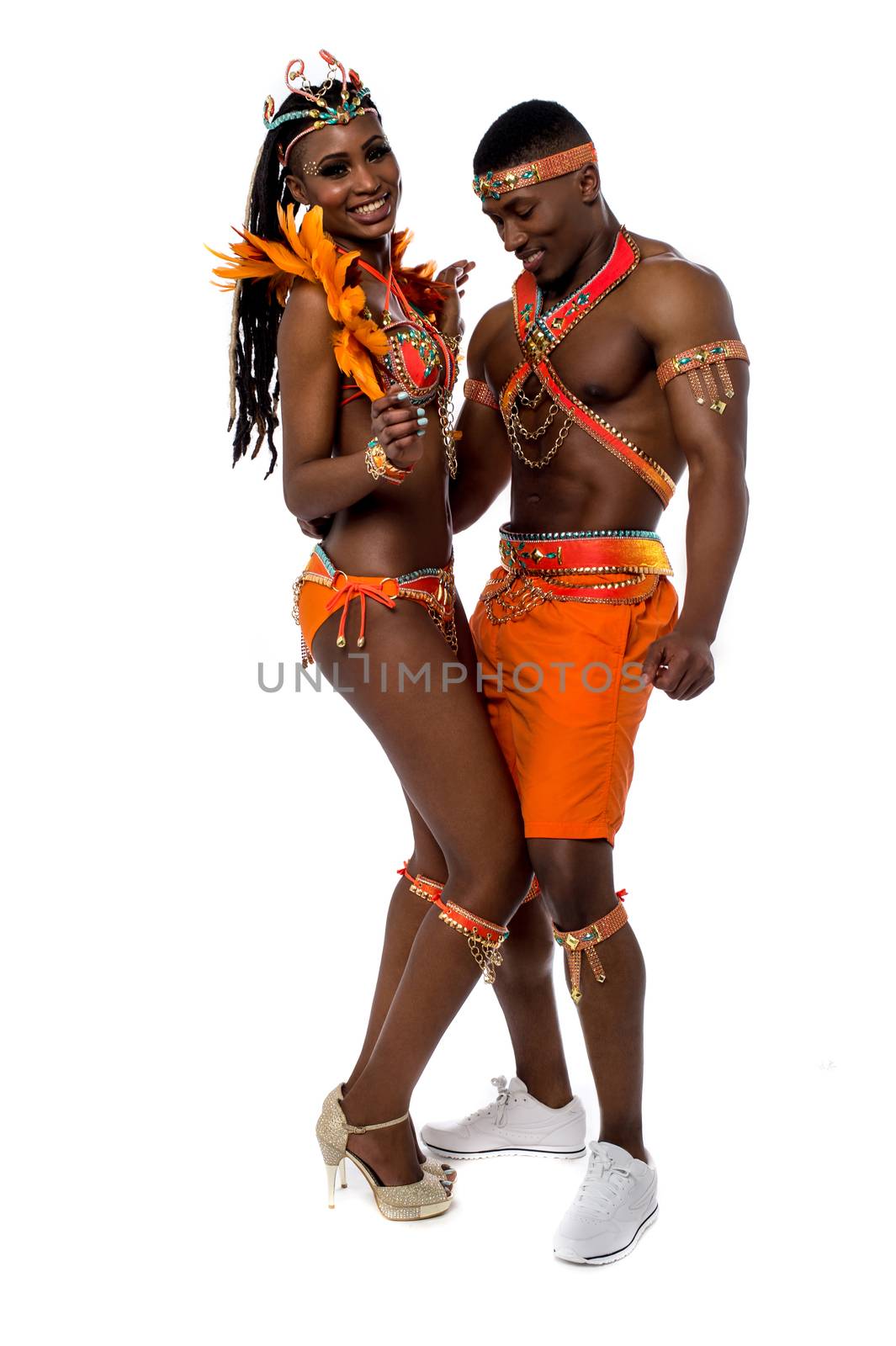 Young couple performing samba dance over white