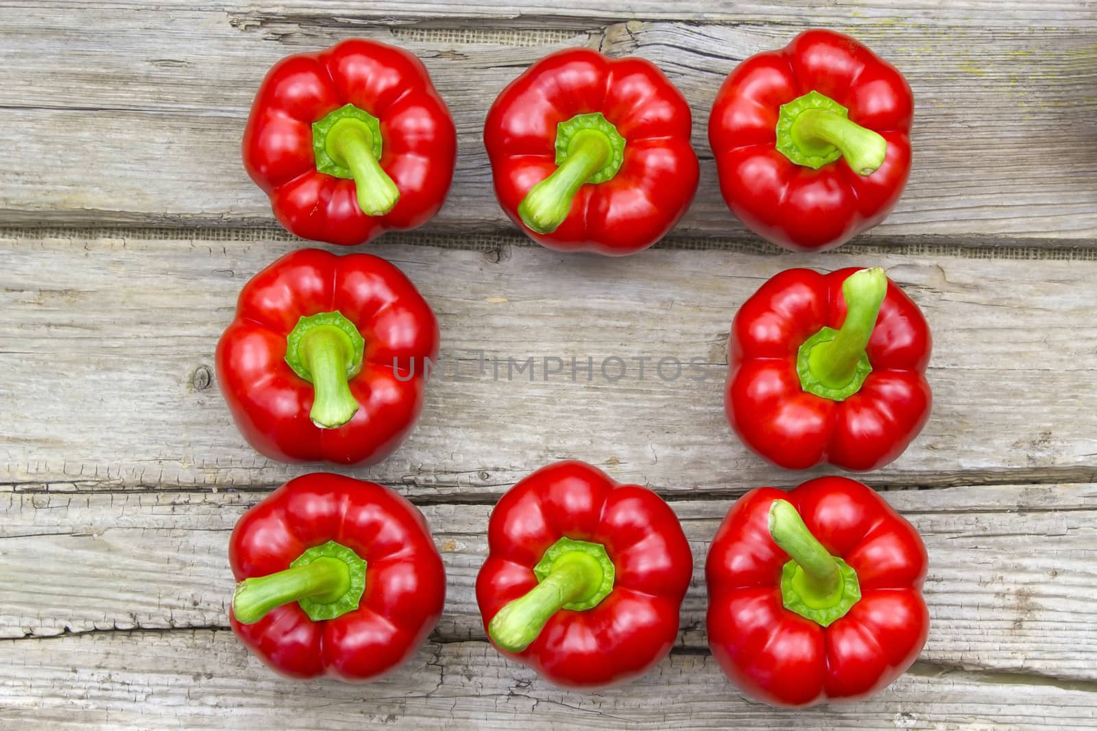 red peppers on wooden background by miradrozdowski