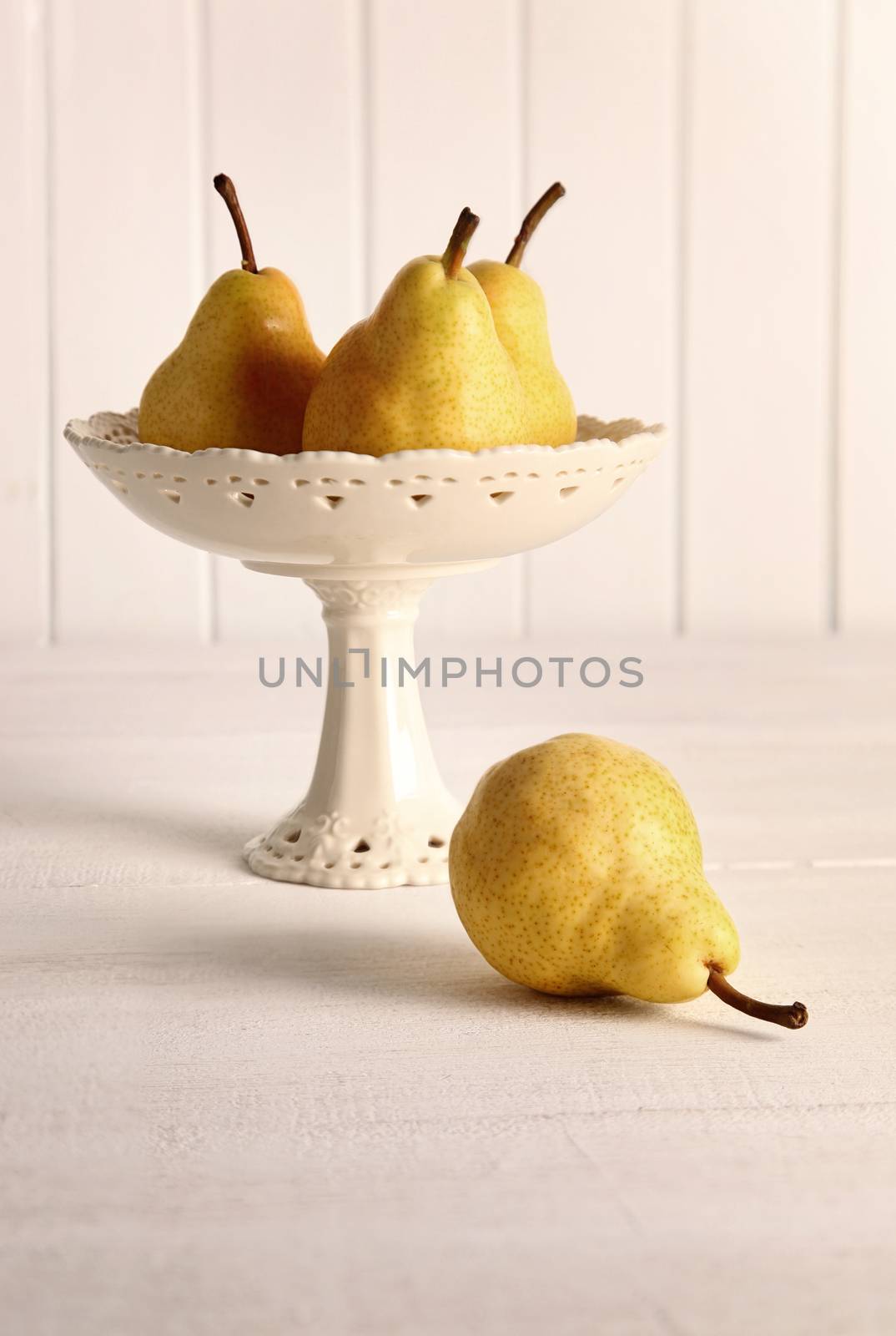 Still life of pears in fruit bowl on table