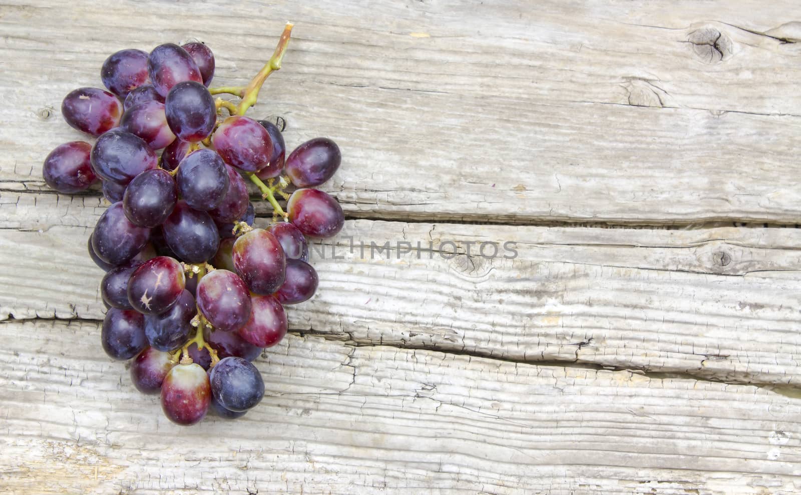 grapes on old wooden background