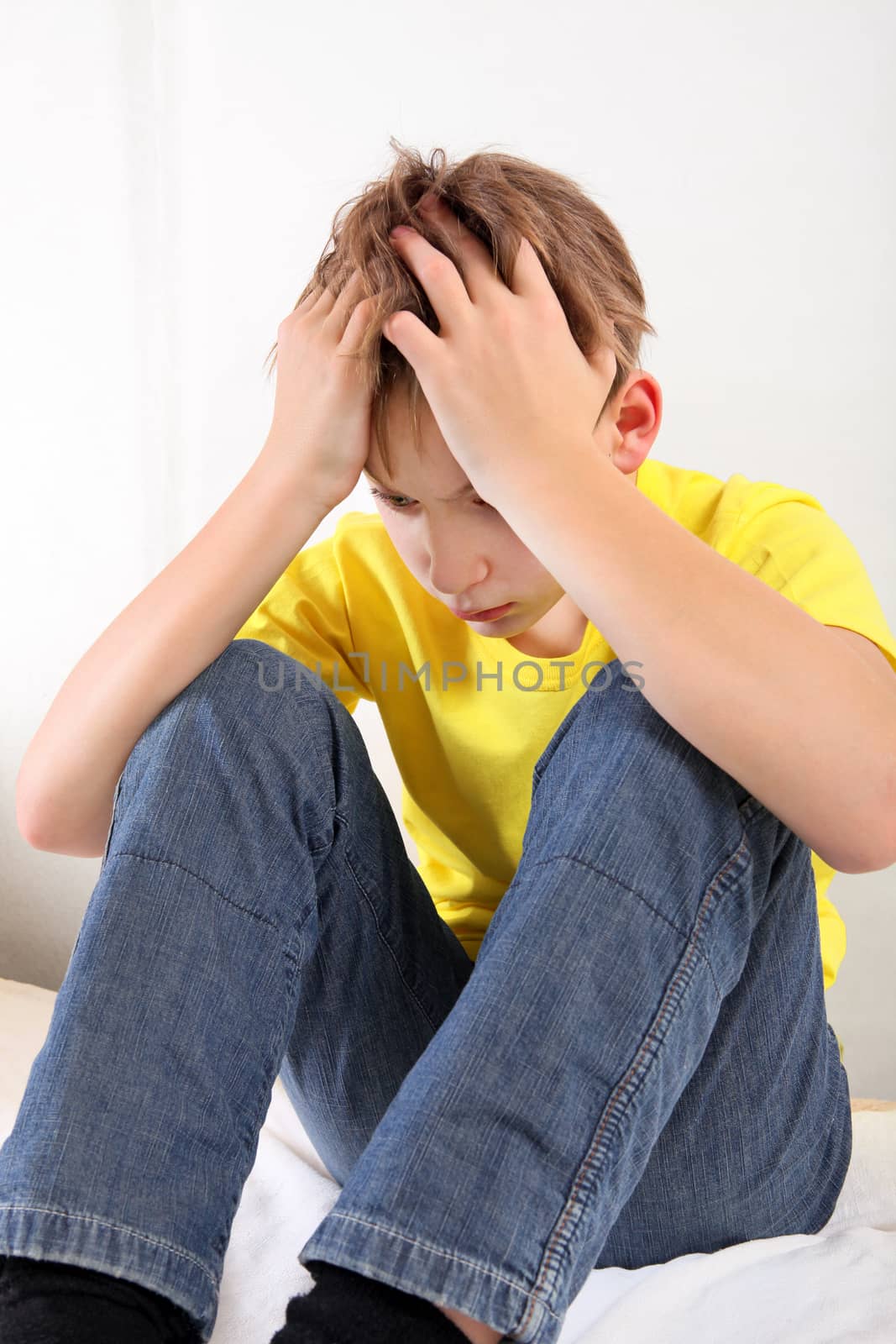 Sad and Troubled Kid on the Bed at the Home