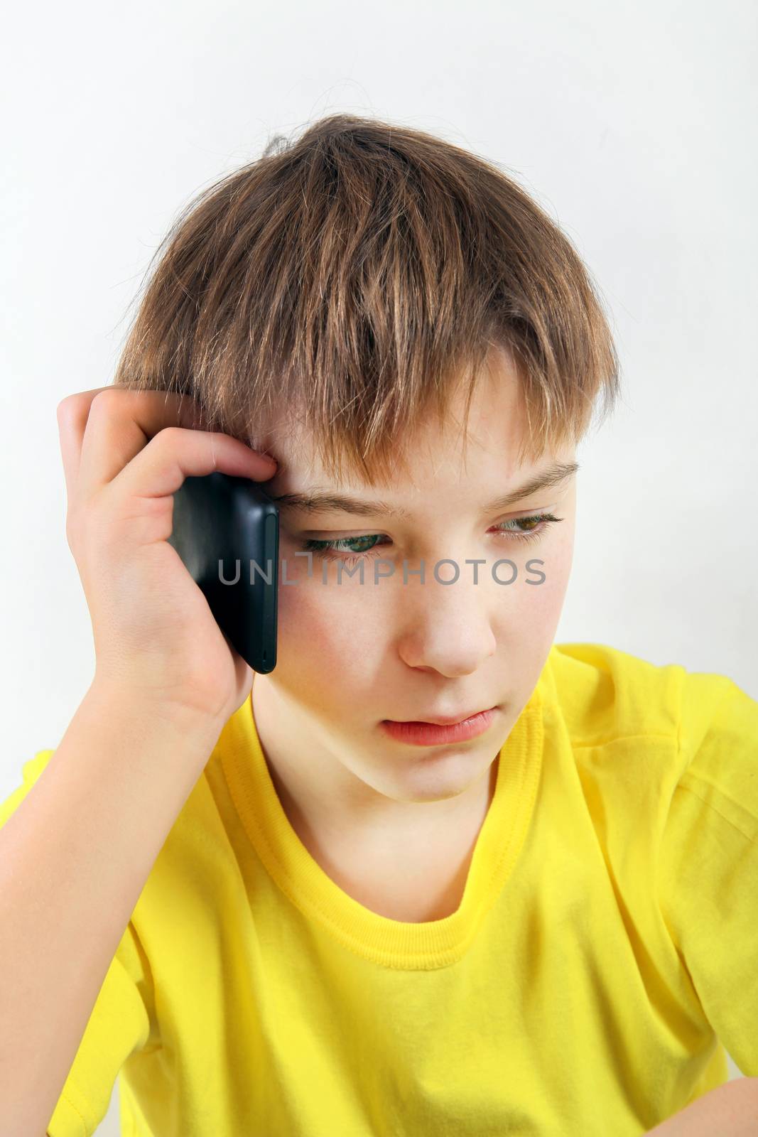 Sad Kid with Cellphone on the White Background