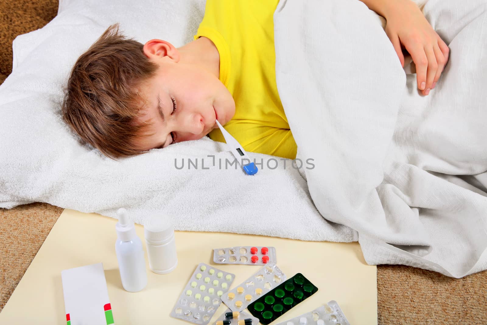 Sick Kid with Thermometer in the Bed