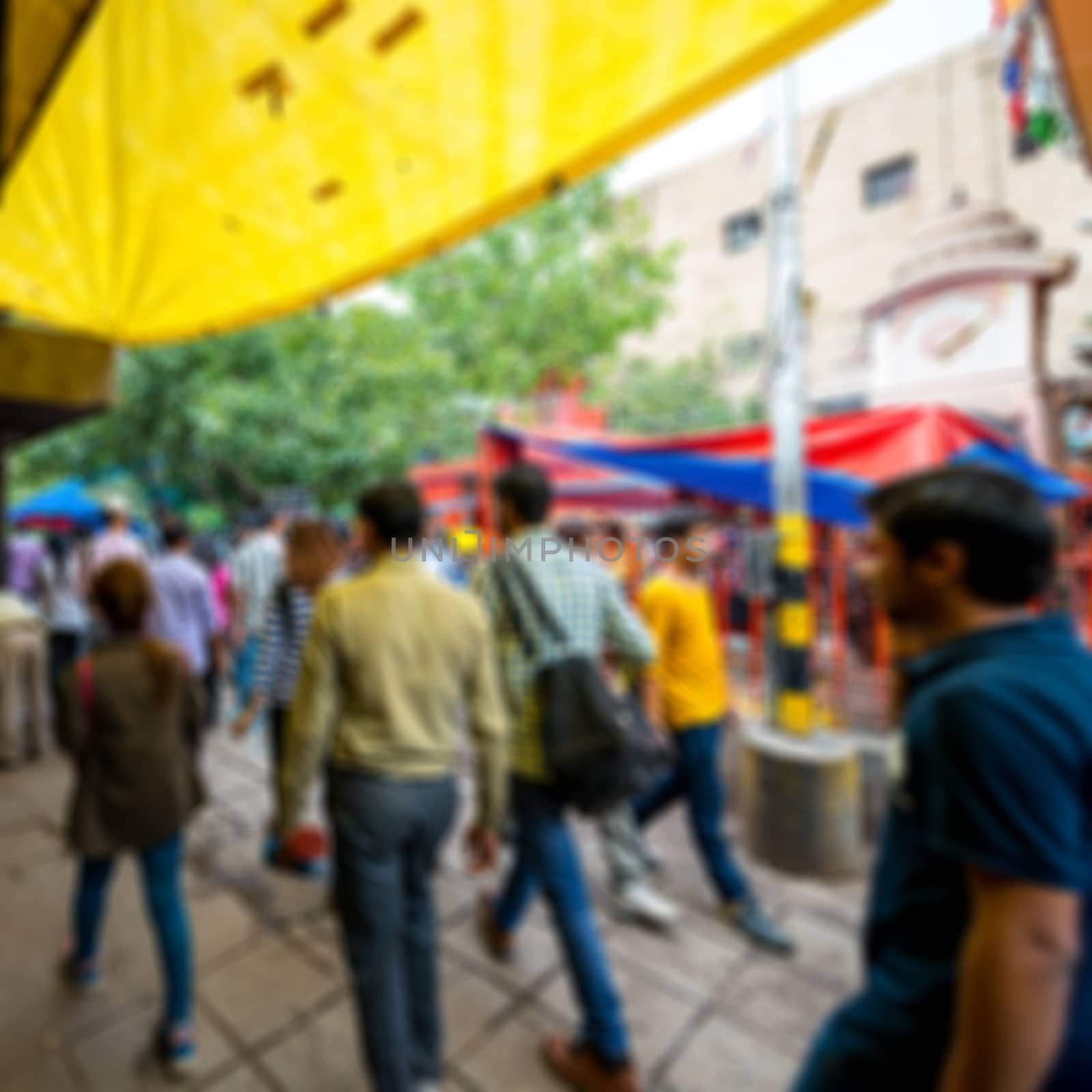 Blurred background of people walk in the street