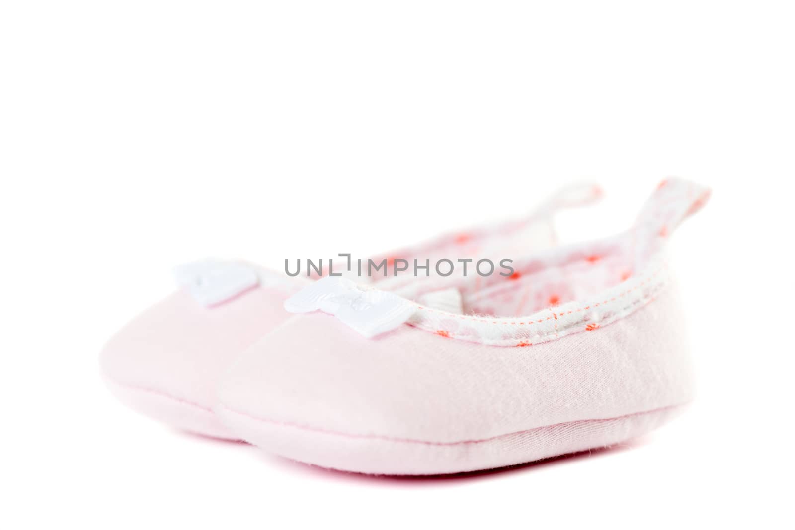 Close up pink baby shoes isolated on white background