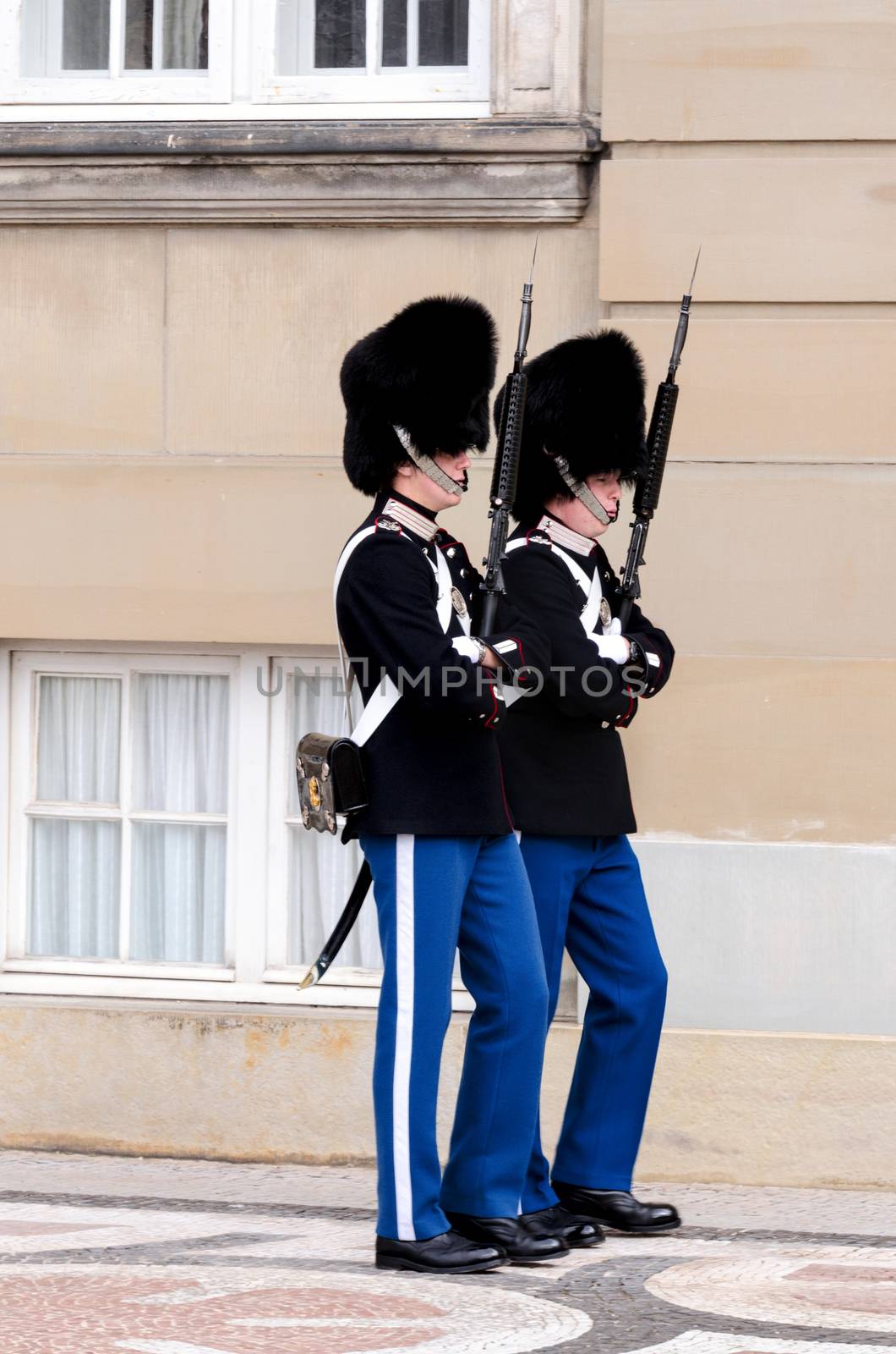 COPENHAGEN, DENMARK - AUGUST 23 : Royal guard at Amalienborg Slot at August 23, 2012 in Copenhagen, Denmark. This palace is the home of the Danish royal family and a top tourist attraction as well.