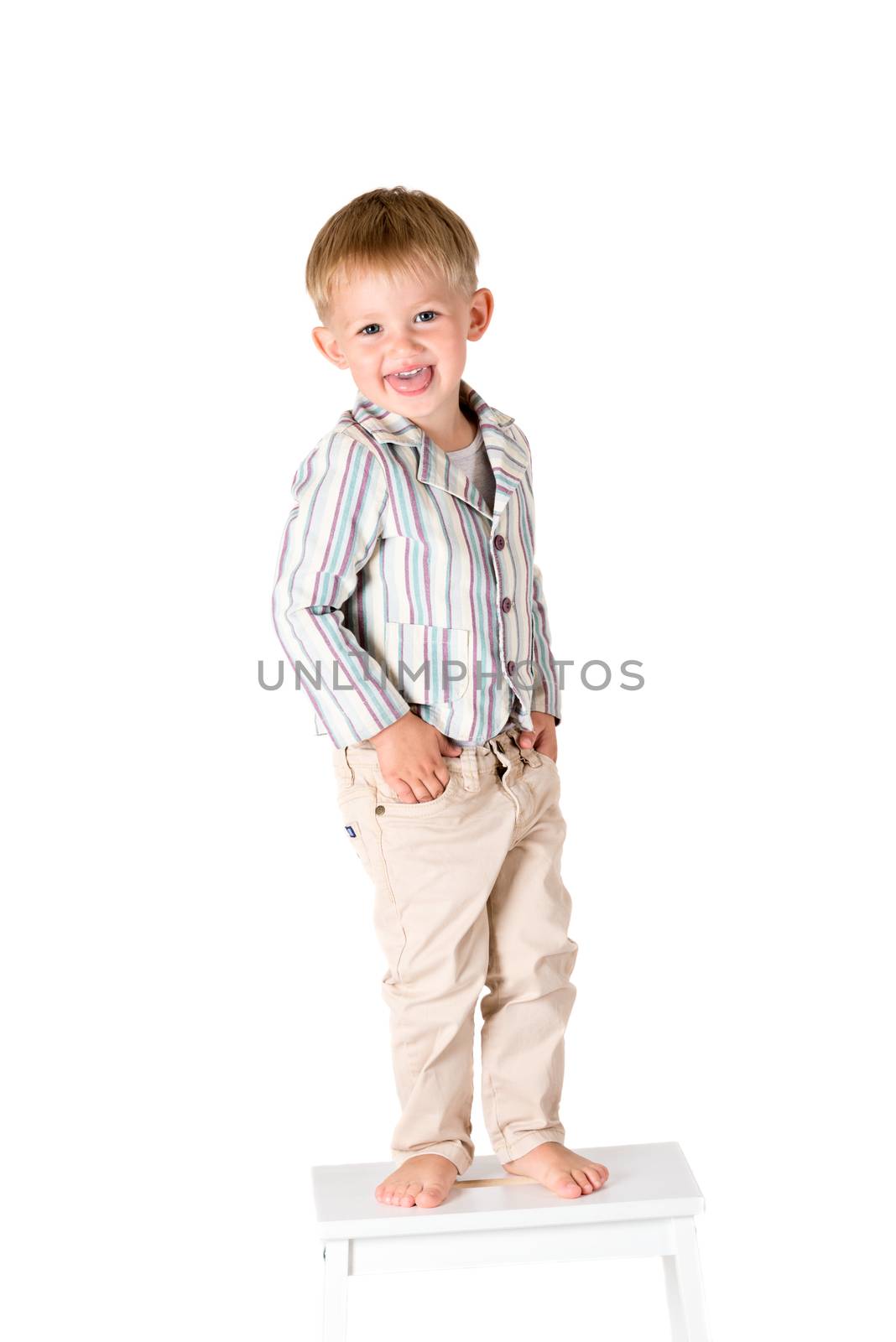 Boy shot in the studio on a white background showing tongue by Nanisimova