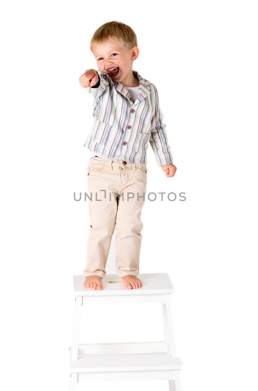 Boy shot in the studio on a white background standing pointing by Nanisimova