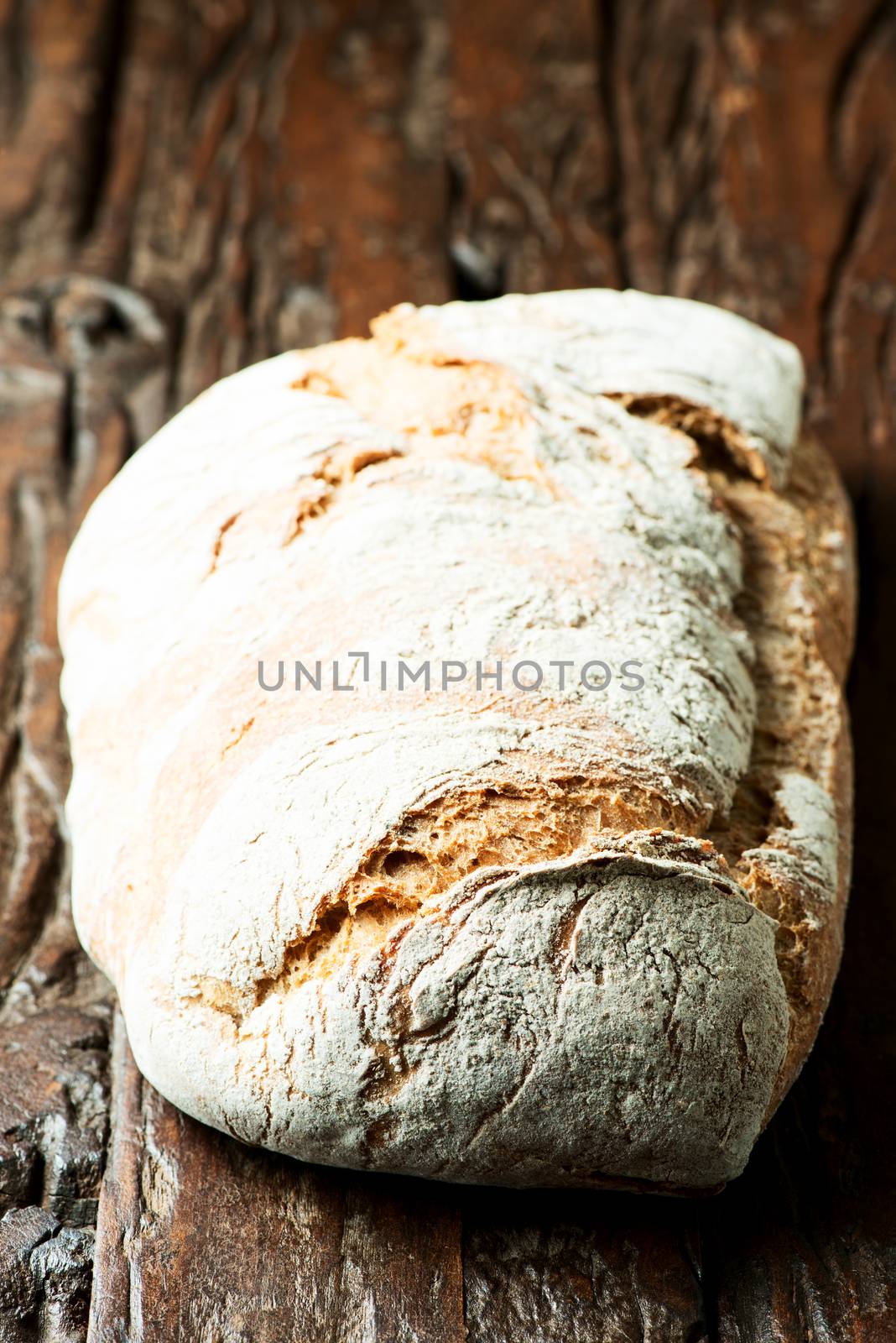 Large loaf of bread on wooden table
