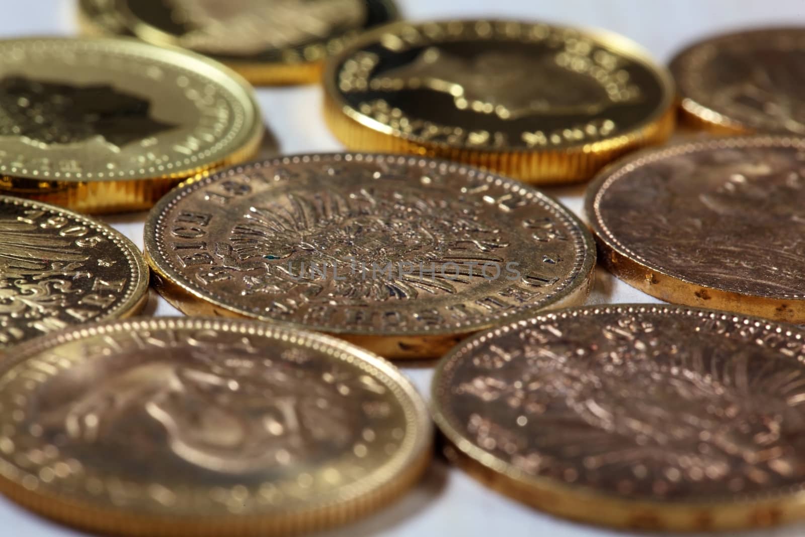 Old gold coins on a wood background.