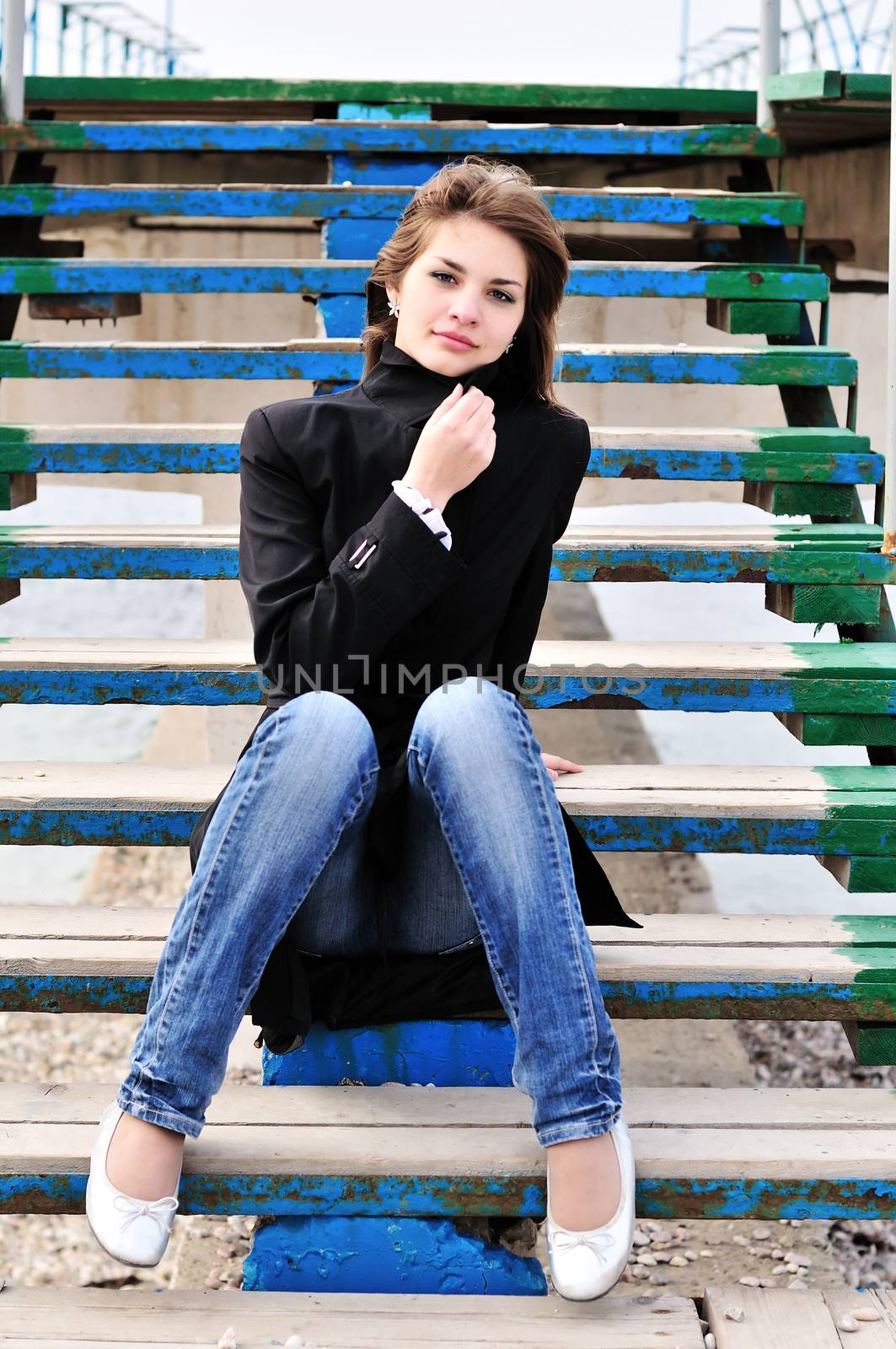 Pretty teen girl sitting on the stairs 