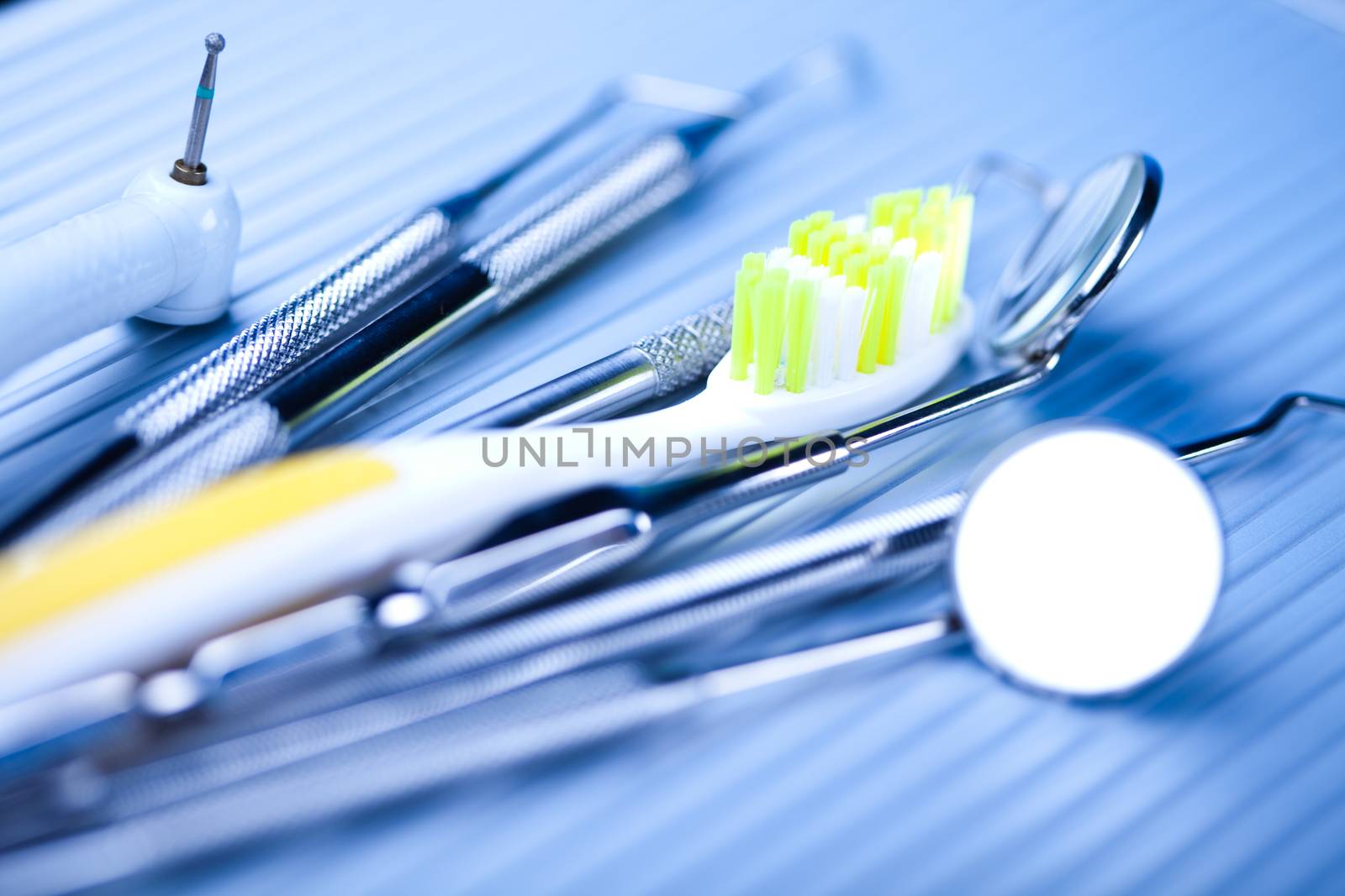 Dentist equipment on blue background by JanPietruszka