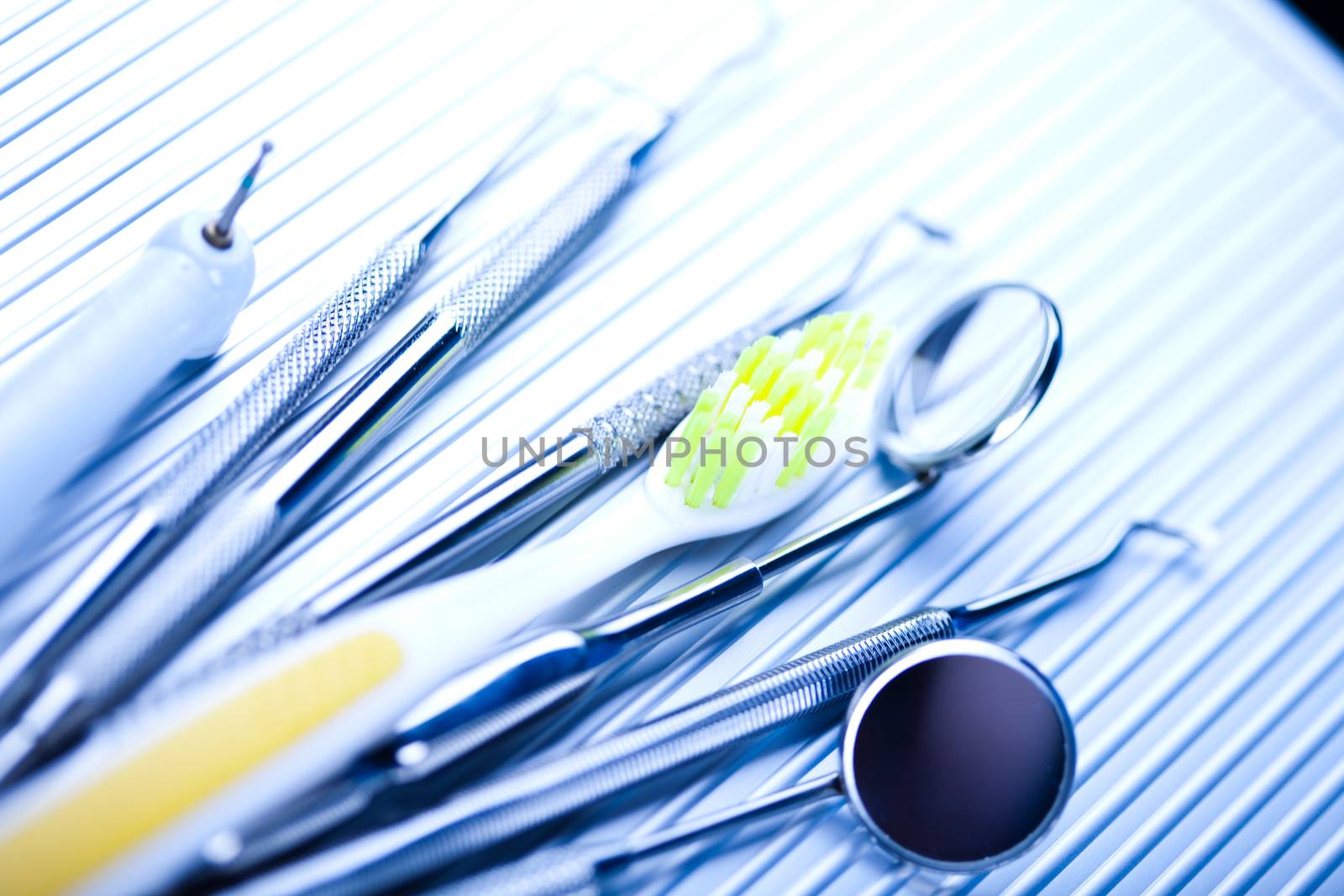 Dentist equipment on blue background by JanPietruszka