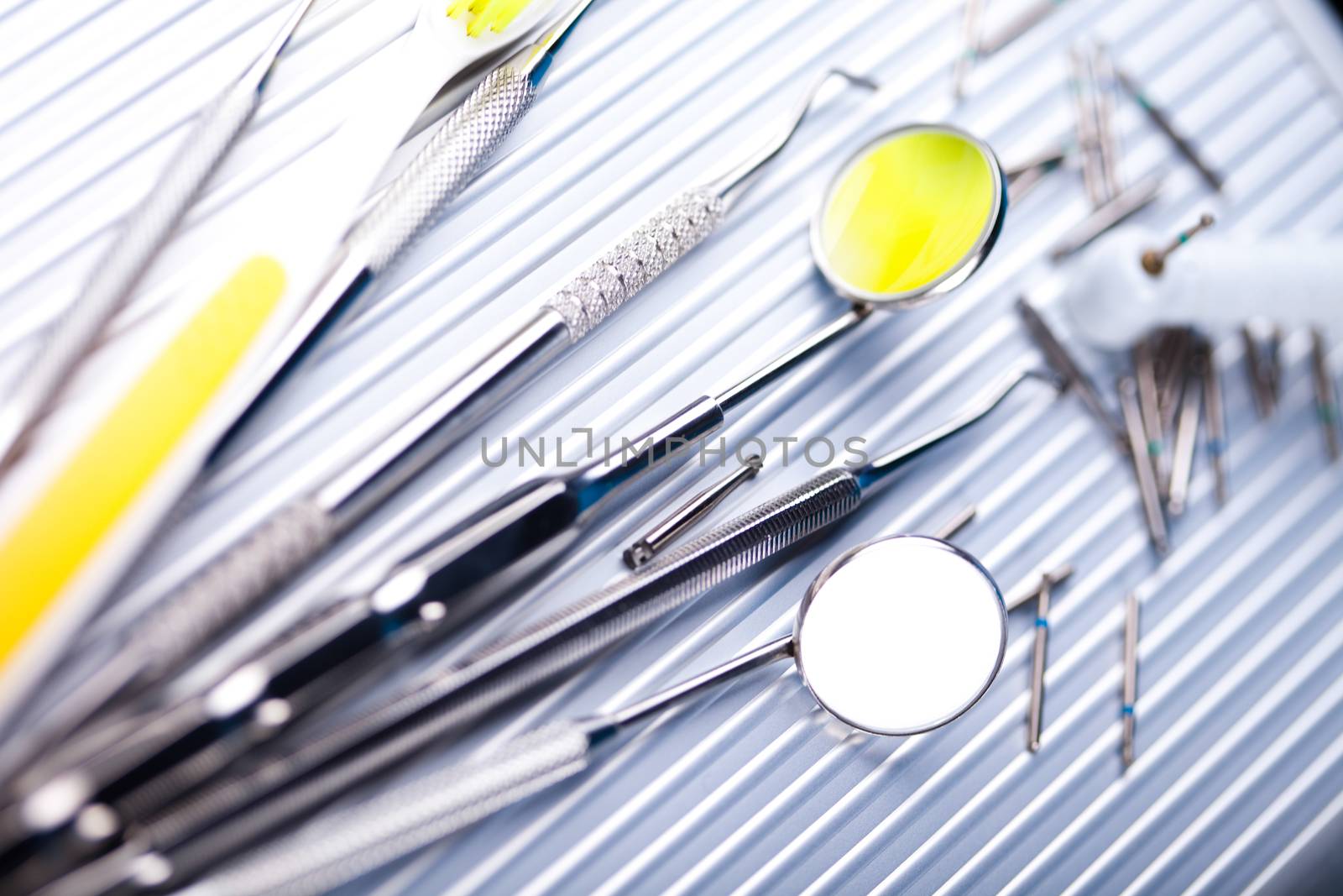 Dentist equipment on blue background by JanPietruszka