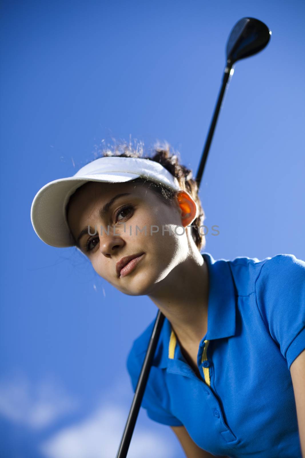 Girl playing golf on grass in summer