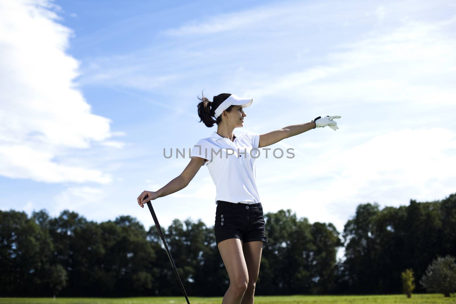 Girl playing golf on grass in summer