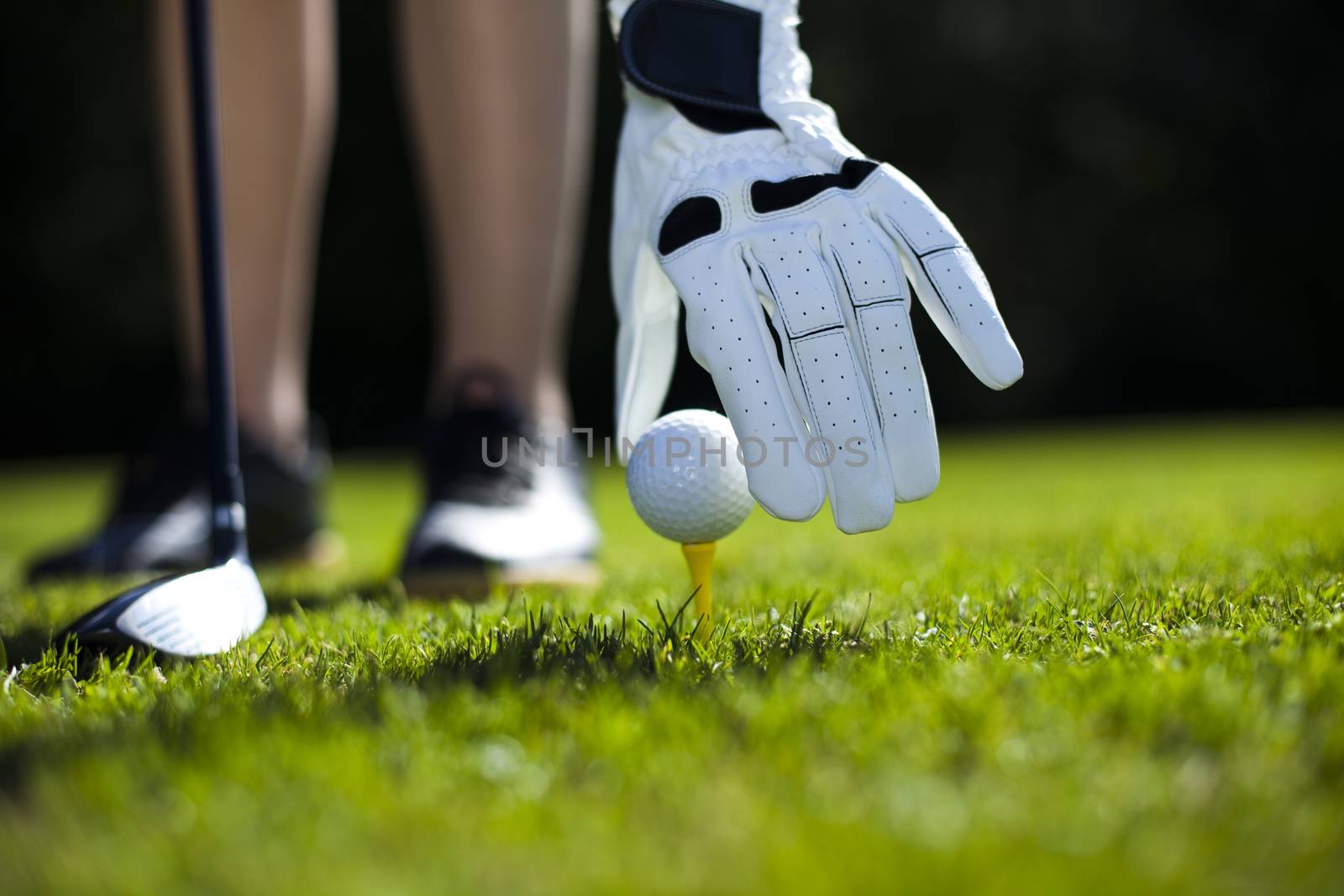 Girl playing golf on grass in summer