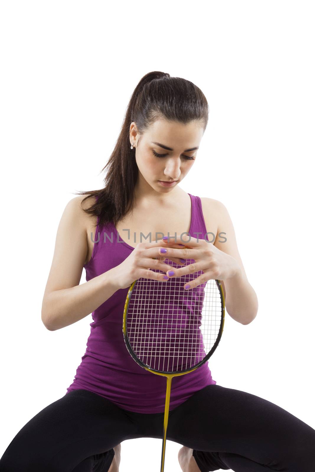 Beautiful girl holding badminton racket isolated on white background. Active healthy lifestyle.