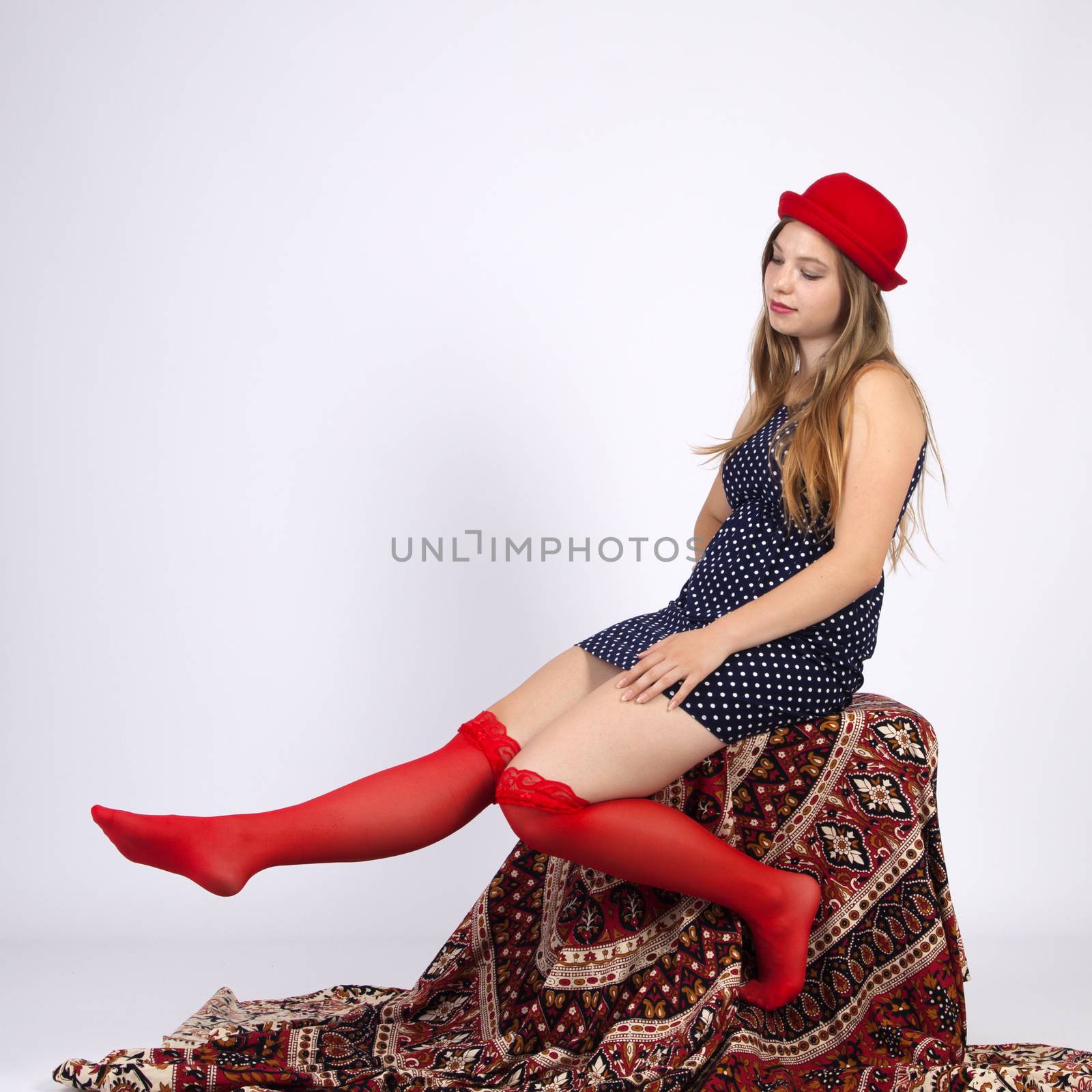 Young woman in red hat in garters