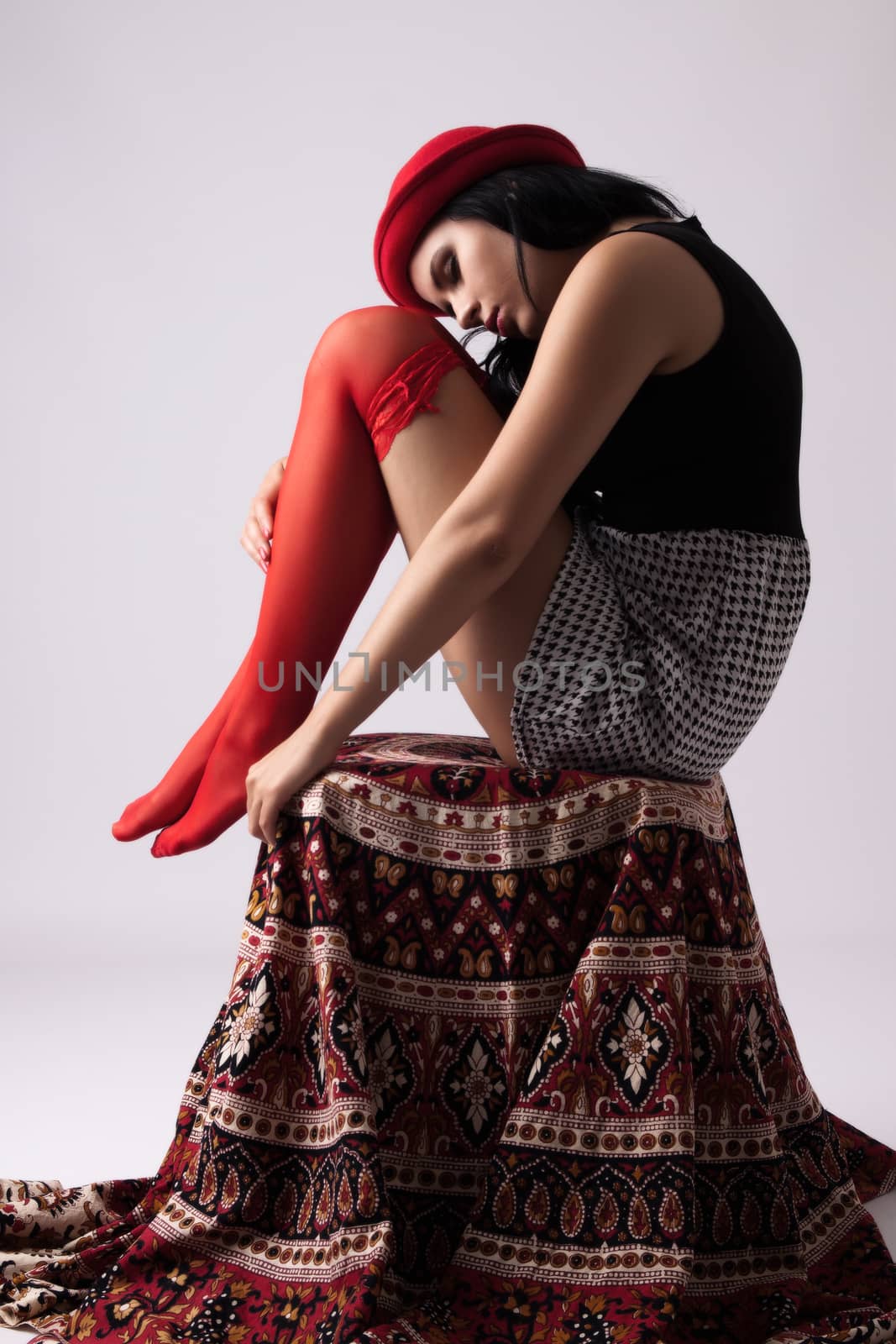 Young woman in red hat in garters