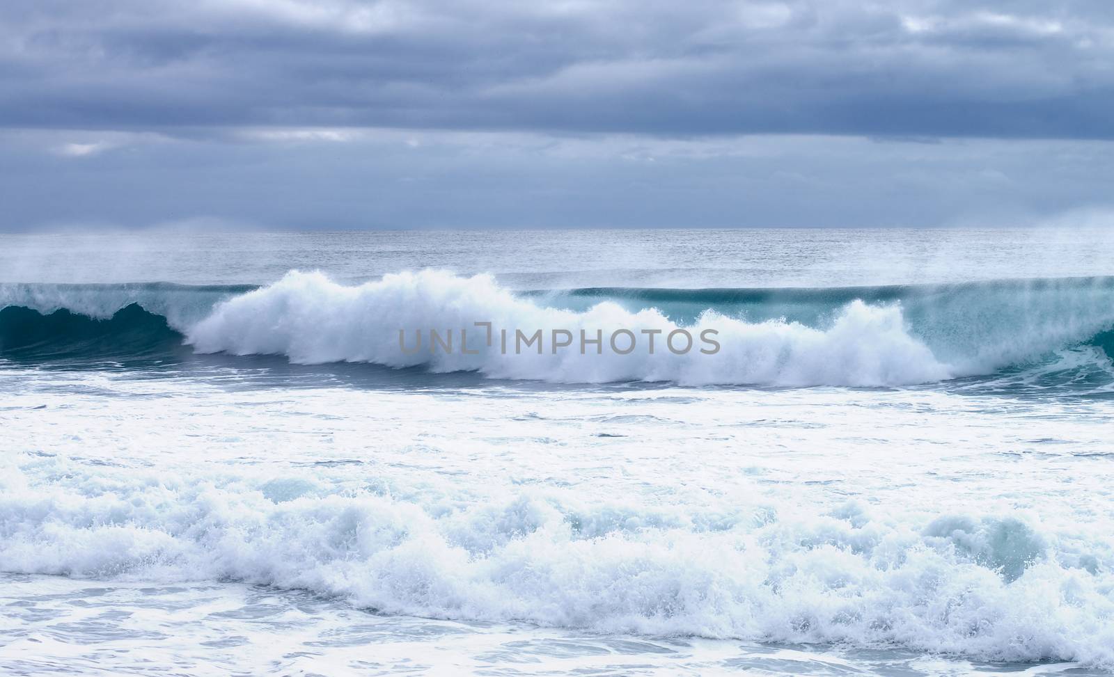 Powerful Splashing Waves on Dramatic Skies background Outdoors on Mediterranean Shore, Spain