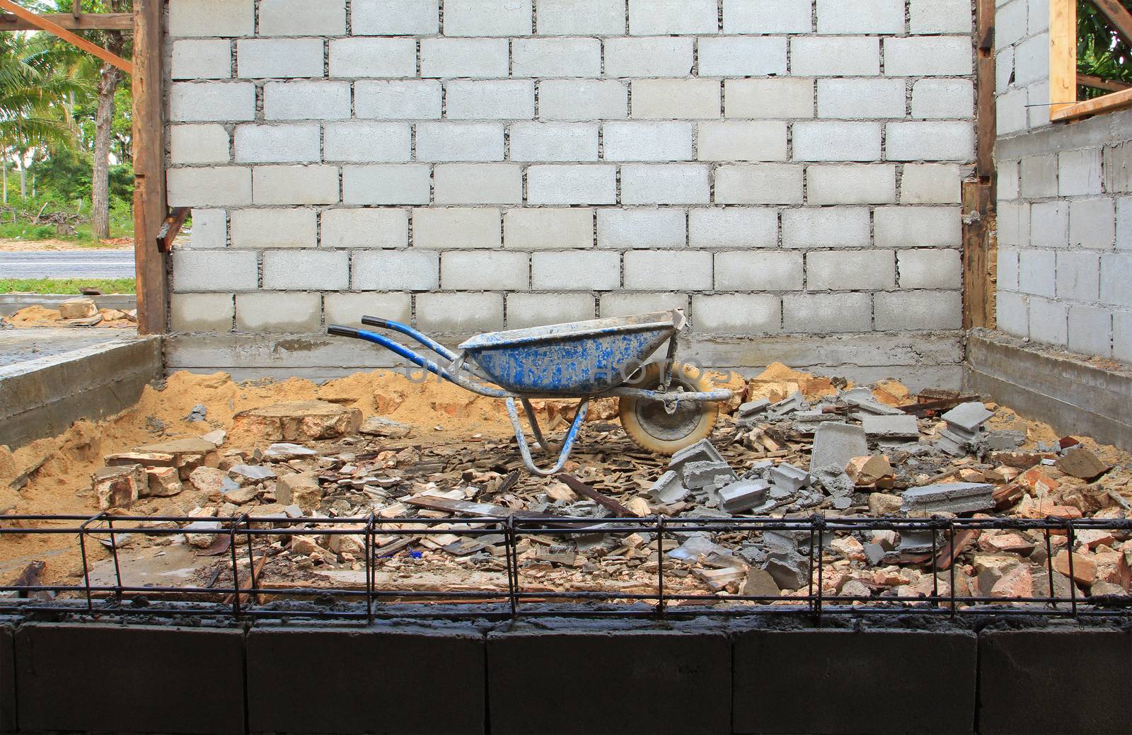 Old rusty wheelbarrow in construction site