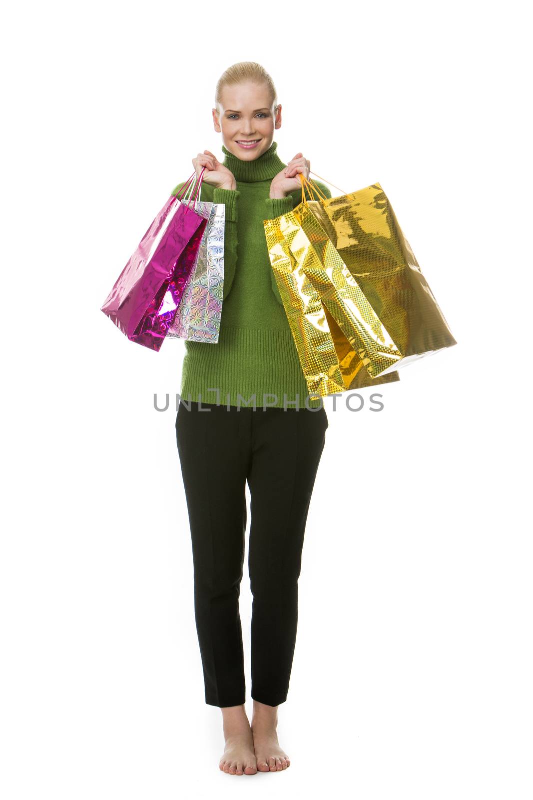 blonde smiling woman carrying gift bags and looking at the camera