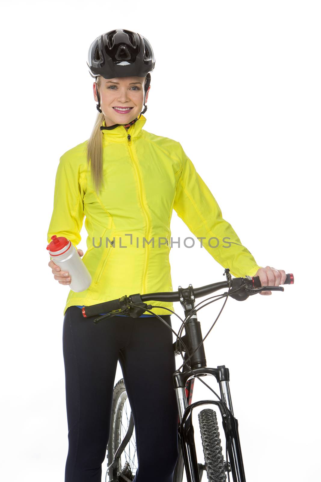 blonde woman wearing fitness clothing and helmet while drinking next to a bike