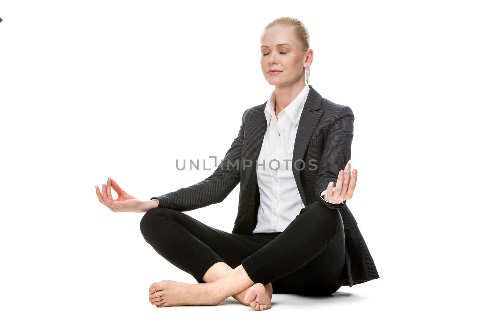 businesswoman doing yoga by Flareimage