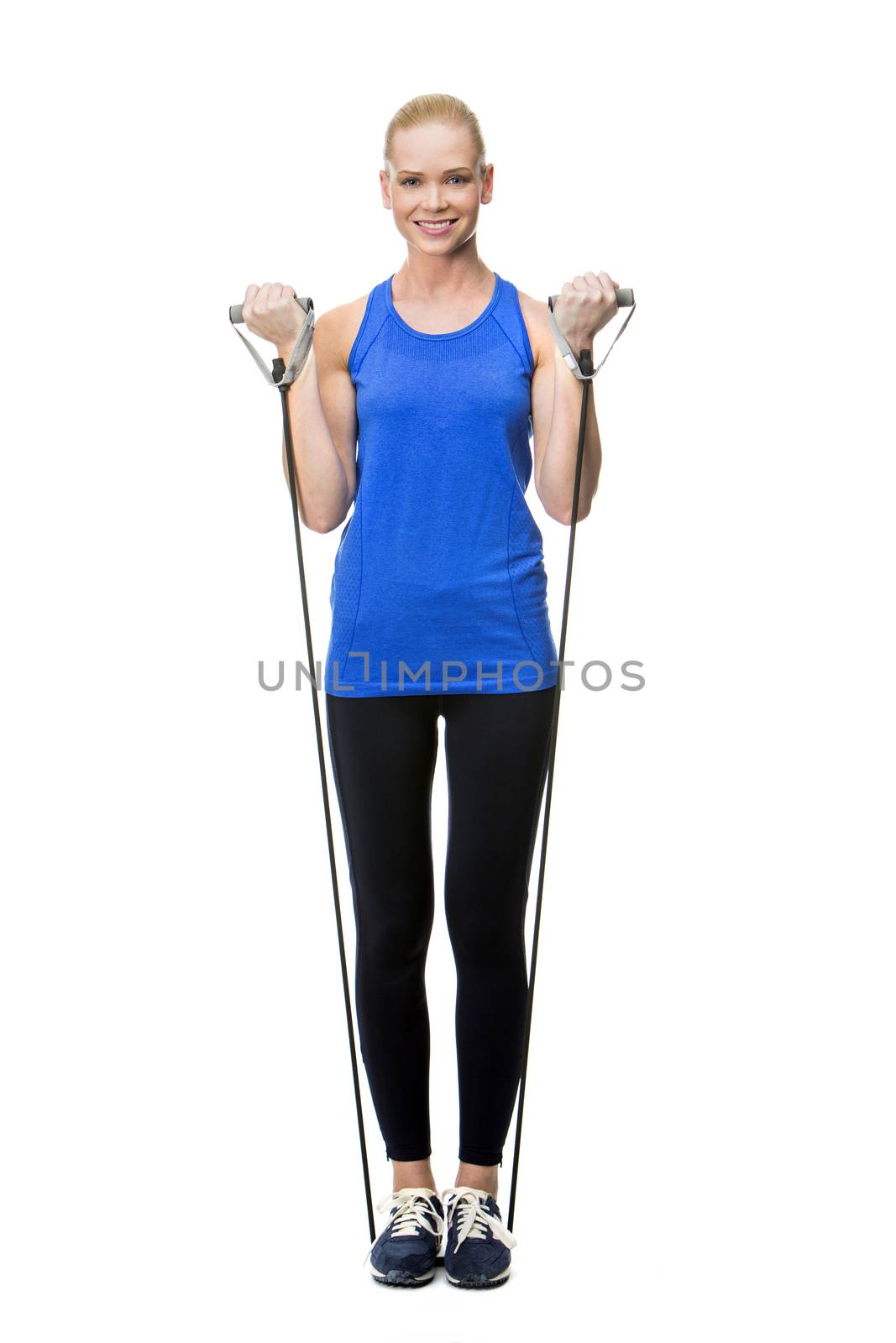 blonde woman wearing fitness clothing exercising with rubber band