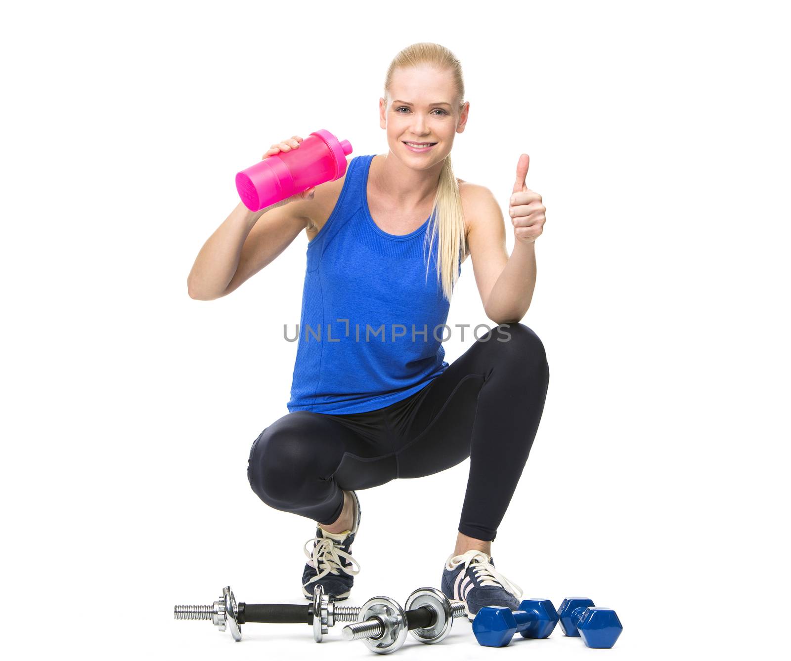 woman in fitness clothing drinking by Flareimage