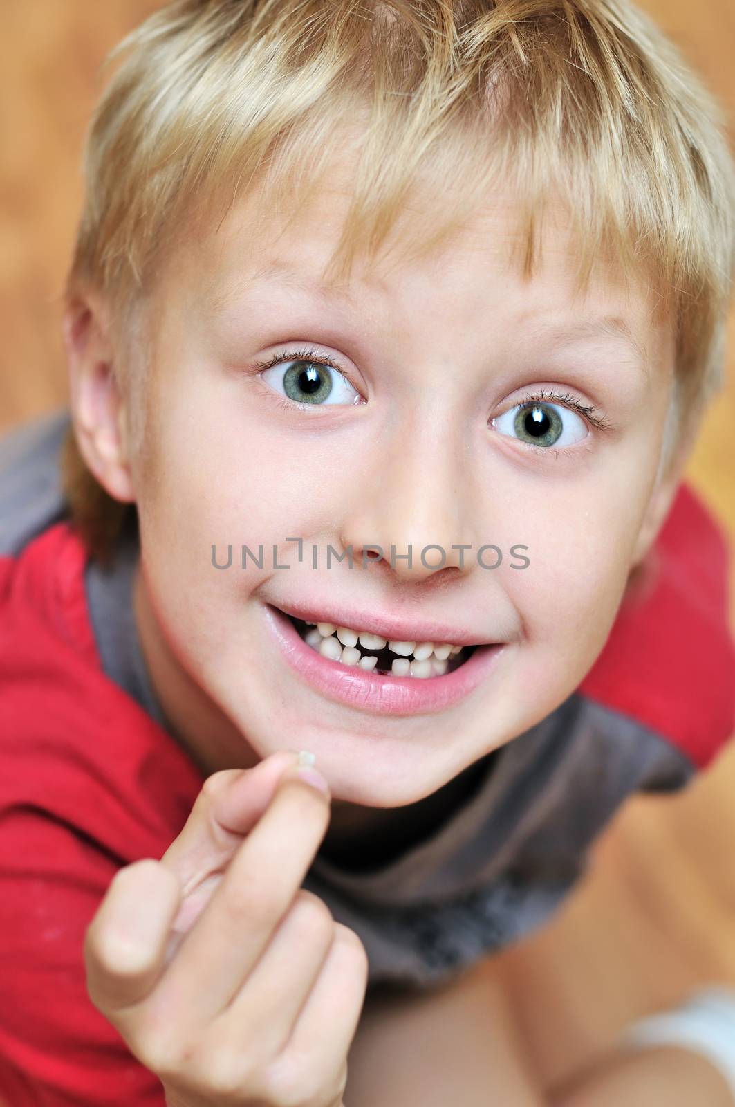 little boy showing his first lost milk-tooth, he is waiting for tooth fairy