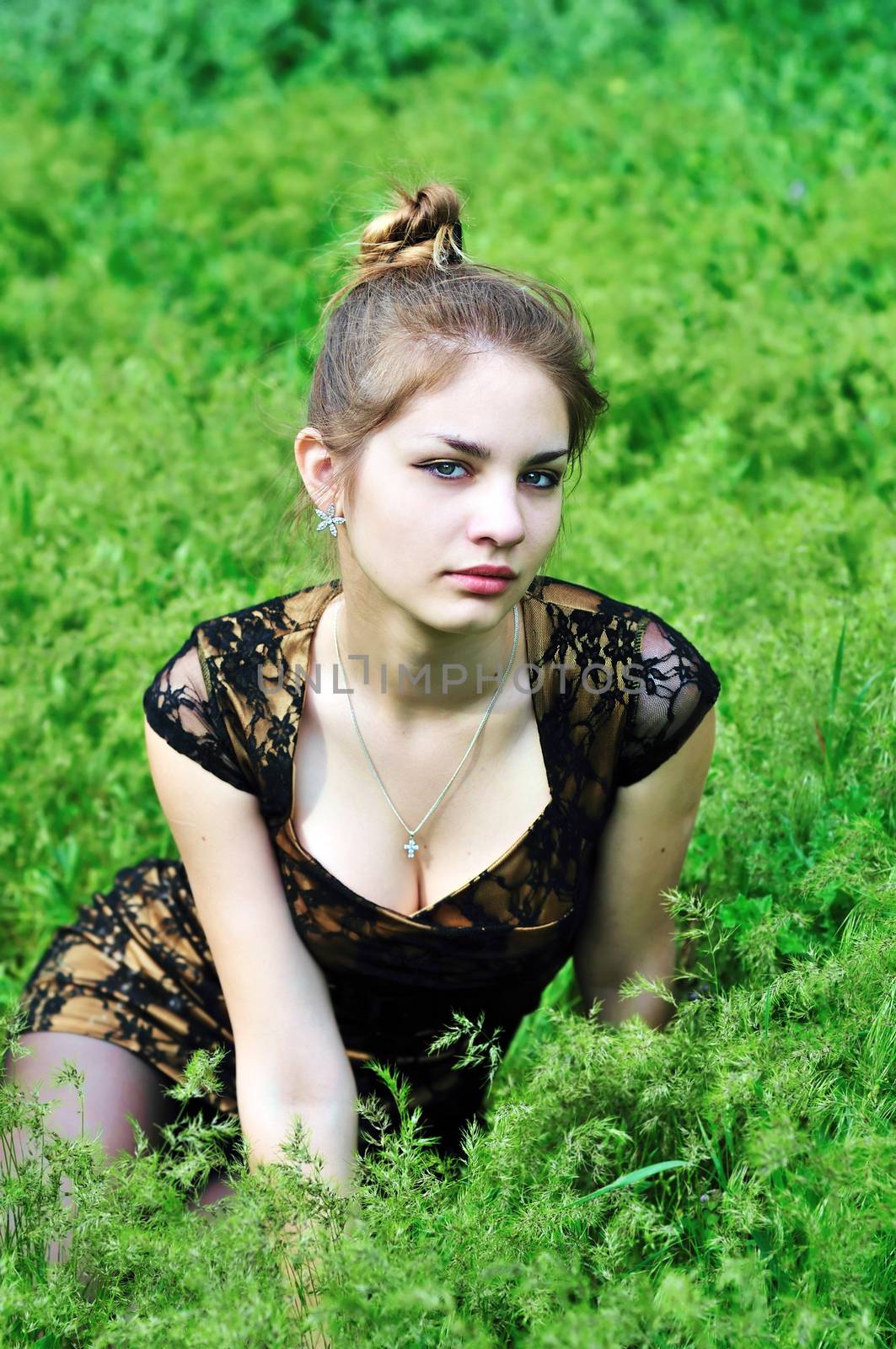 tender teen girl sitting in the high  green grass