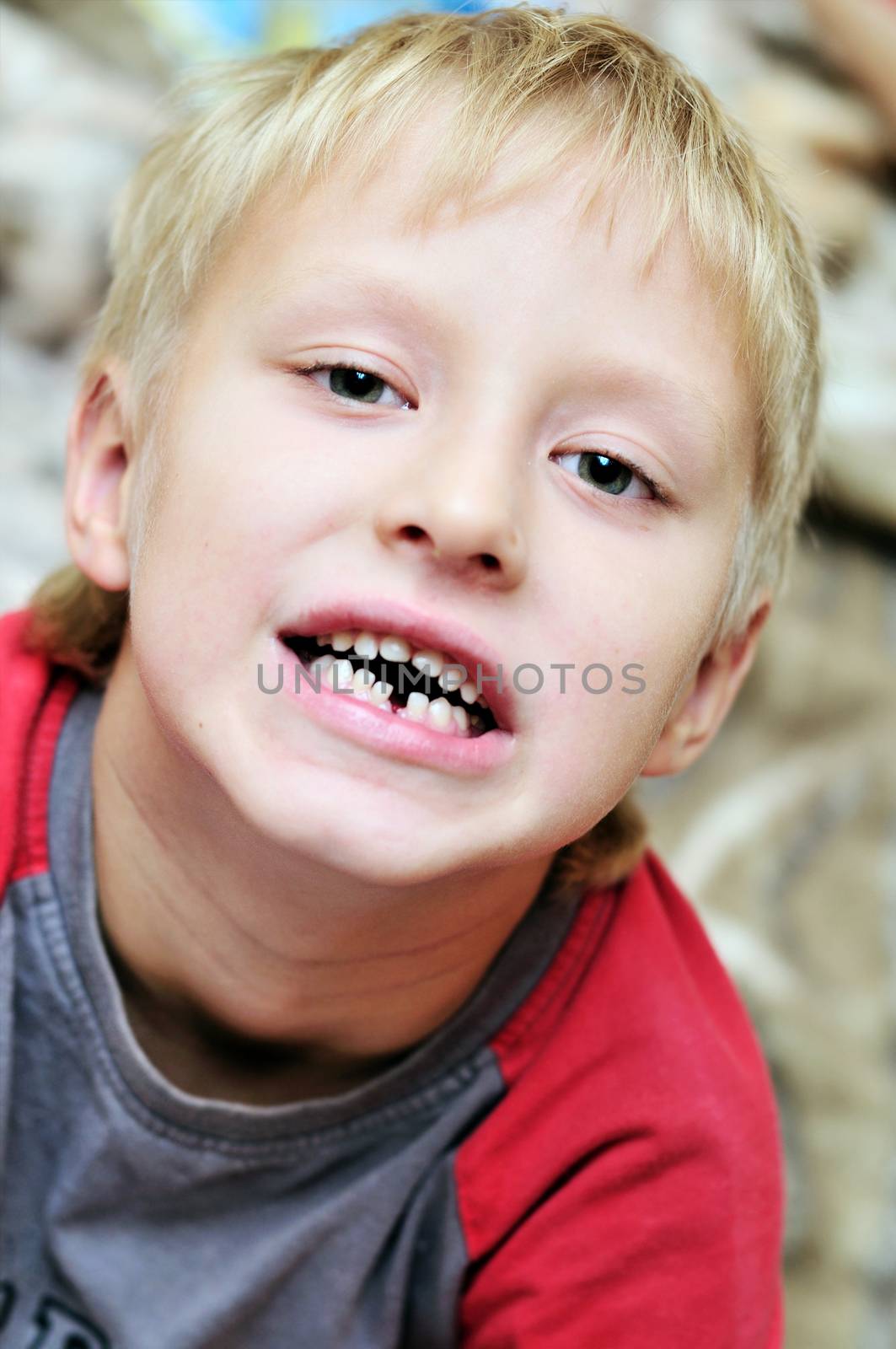 little boy showing that he lost first  milk tooth  